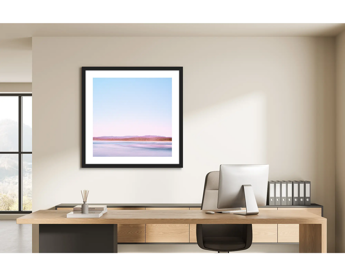 Perspective. Framed wall art print of Pambula Beach, Merimbula, with a black frame and hung in a light filled office. 