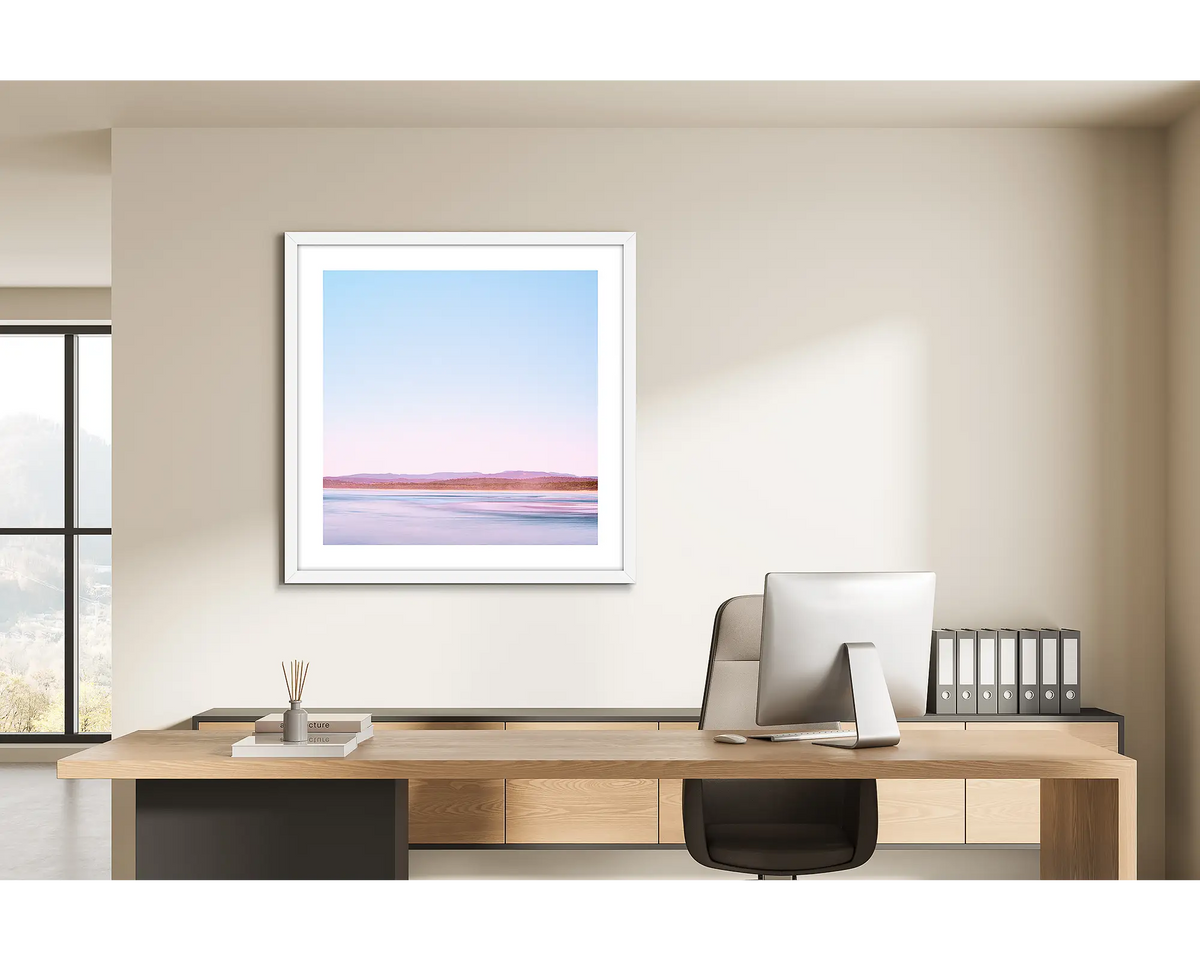 Perspective. Framed wall art print of Pambula Beach, Merimbula, with a white frame and hung in a light filled office. 