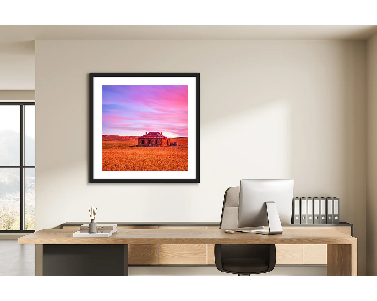 Pioneer. Framed wall art print of an outback farm home, framed with a black frame and hung in a light filled office. 