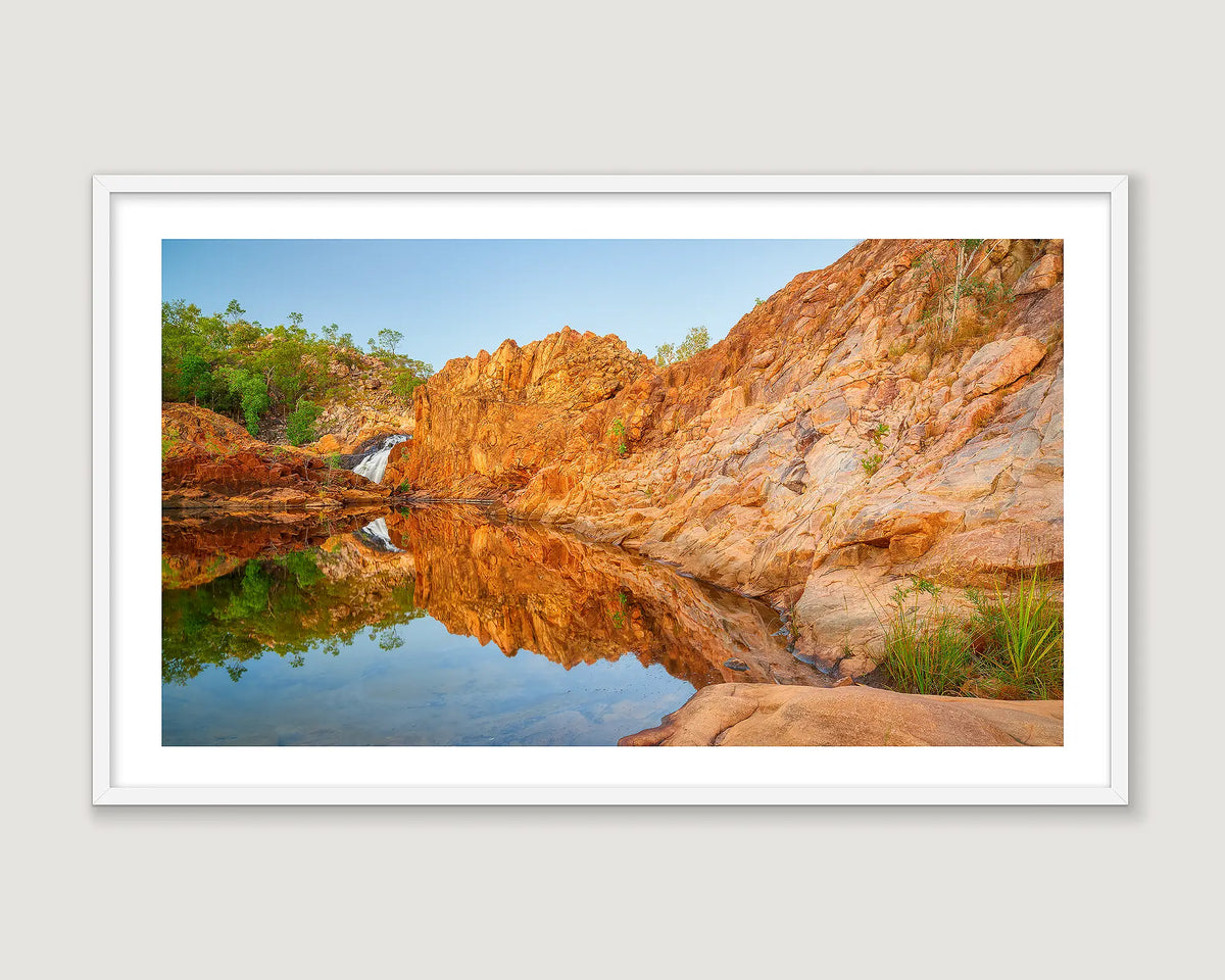 Framed wall art print of a rock pool reflecting a blue sky and a rocky surround in the Katherine region. 