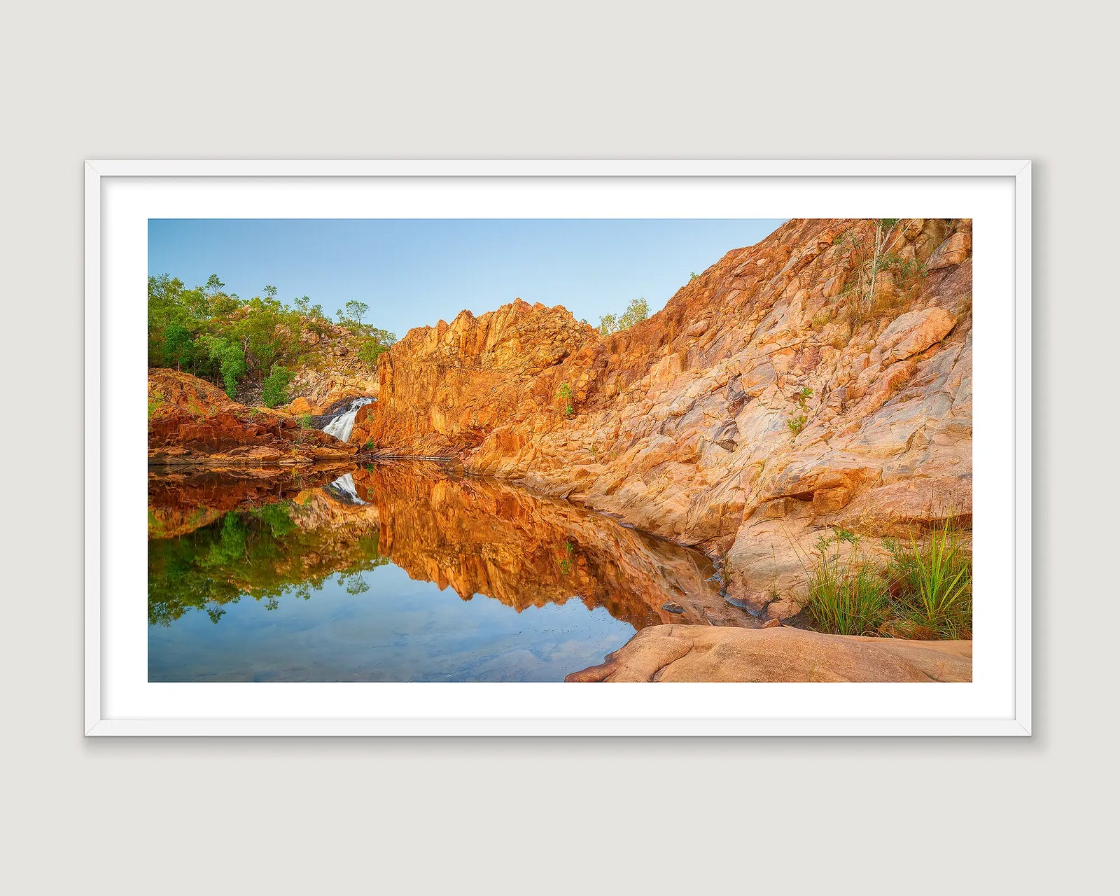 Framed wall art print of a rock pool reflecting a blue sky and a rocky surround in the Katherine region. 