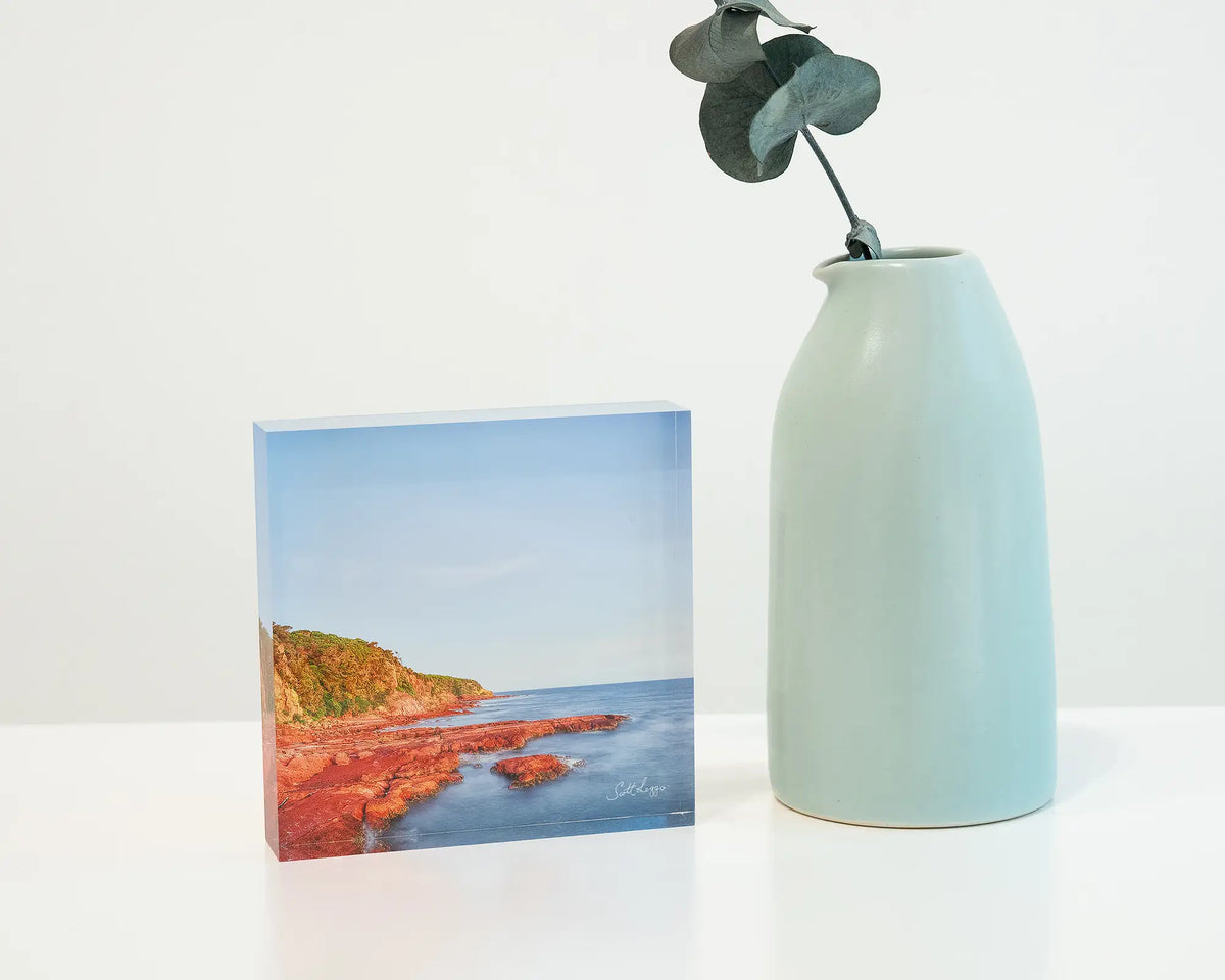 Point. Acrylic block Merimbula Point New South Wales, on desk styled with a small vase.