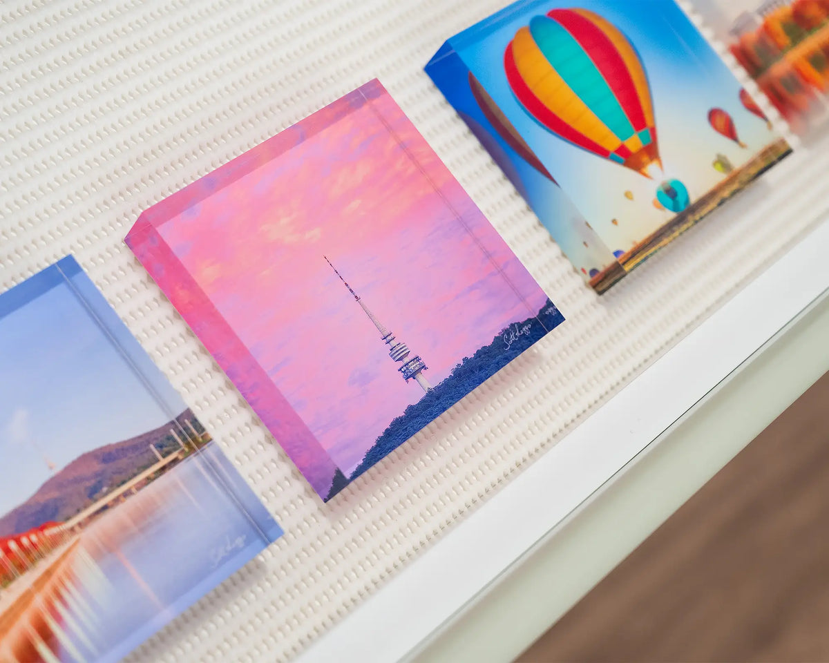 Pointer. Acrylic block of sunrise at Black Mountain Tower, on display in gallery drawer with Canberra acrylic blocks.