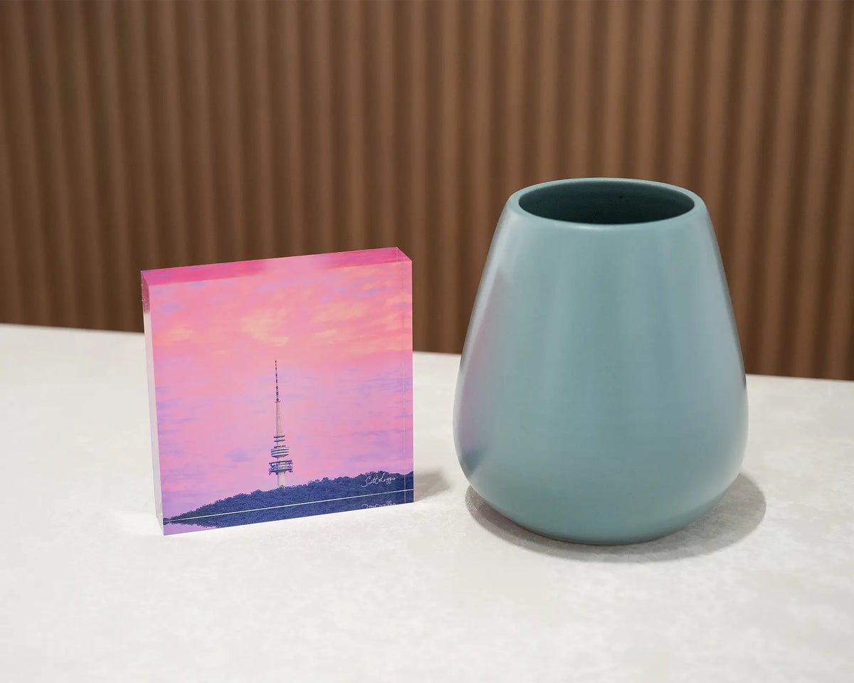 Pointer. Acrylic block of sunrise at Black Mountain Tower, styled with a small vase.