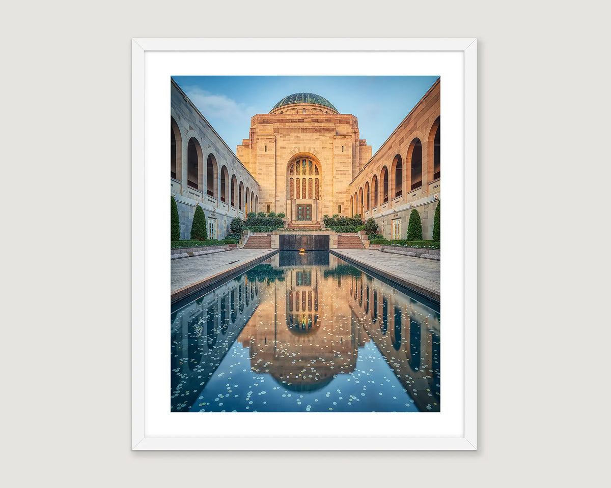 Framed photograph of a memorial building and pool.