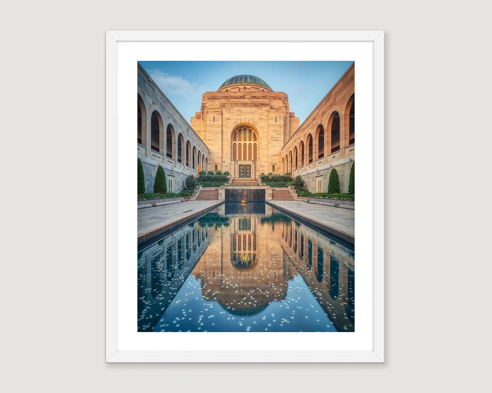 Framed photograph of a memorial building and pool.