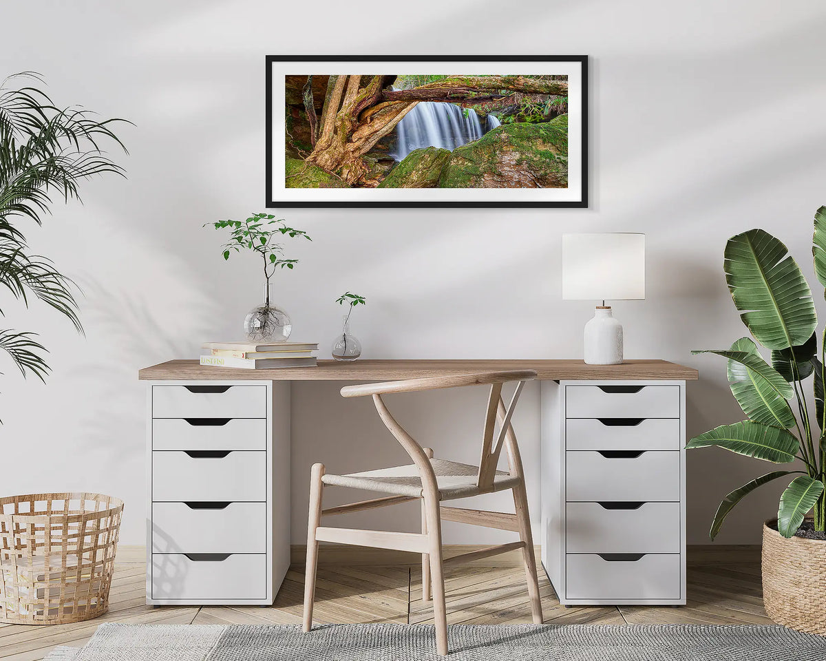 Protected Falls. Wall art print of a waterfall in Morton National Park, with a black frame, hung above a home office desk. 