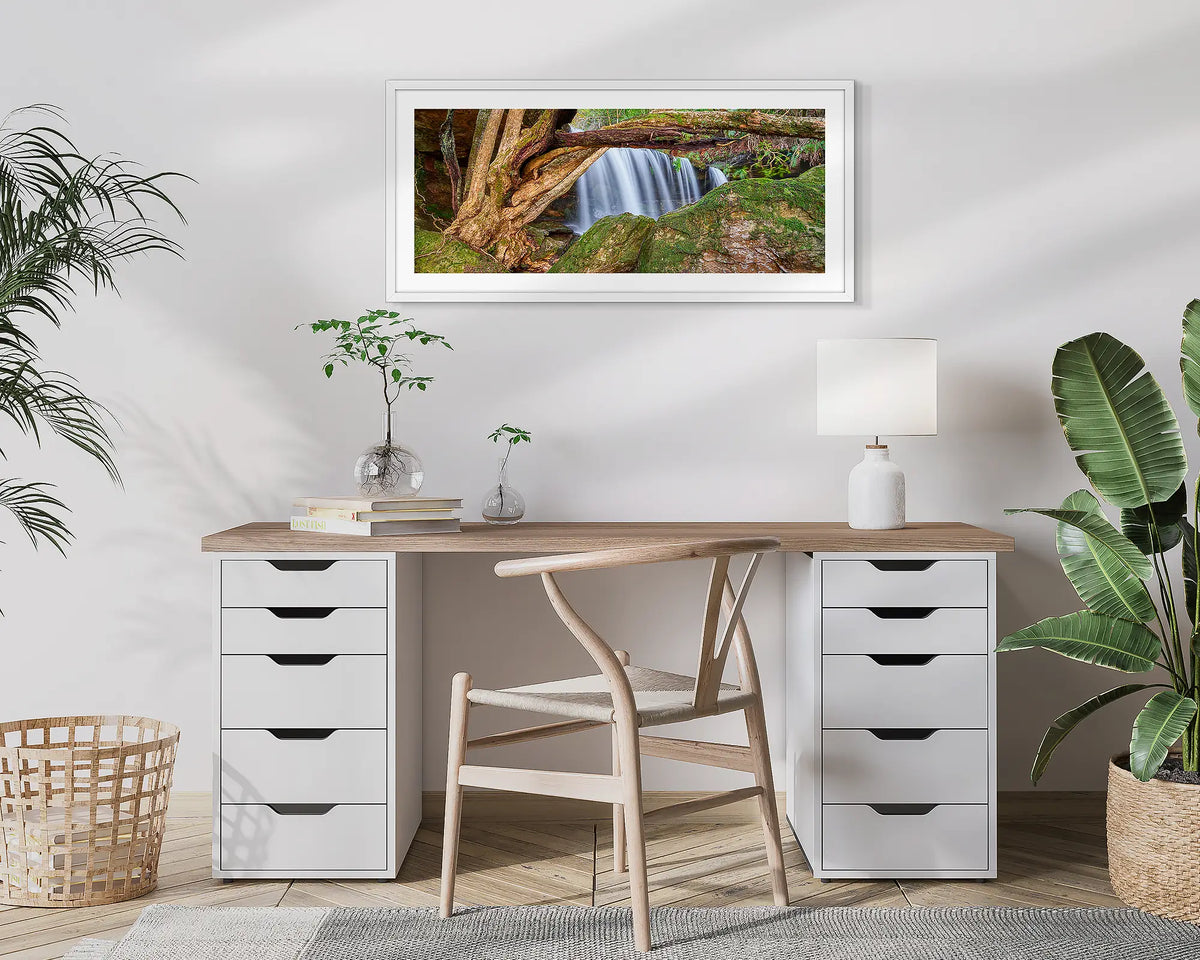 Protected Falls. Wall art print of a waterfall in Morton National Park, with a white frame, hung above a home office desk. 