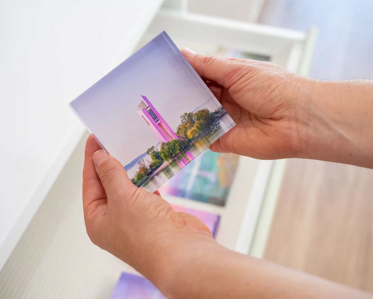 Purple Popsicle. Acrylic block of National Carillon Canberra, with purple lights,  held in hands.