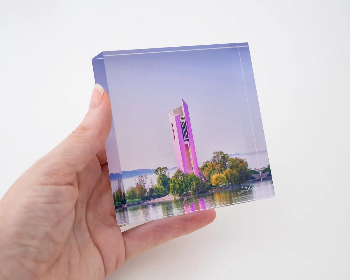 Purple Popsicle. Acrylic block of National Carillon Canberra, with purple lights, held in hand.