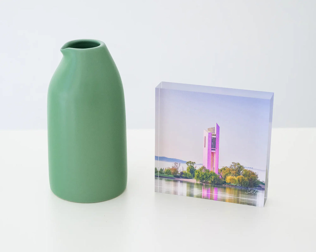 Purple Popsicle. Acrylic block of National Carillon Canberra, with purple lights, styled with a small vase.