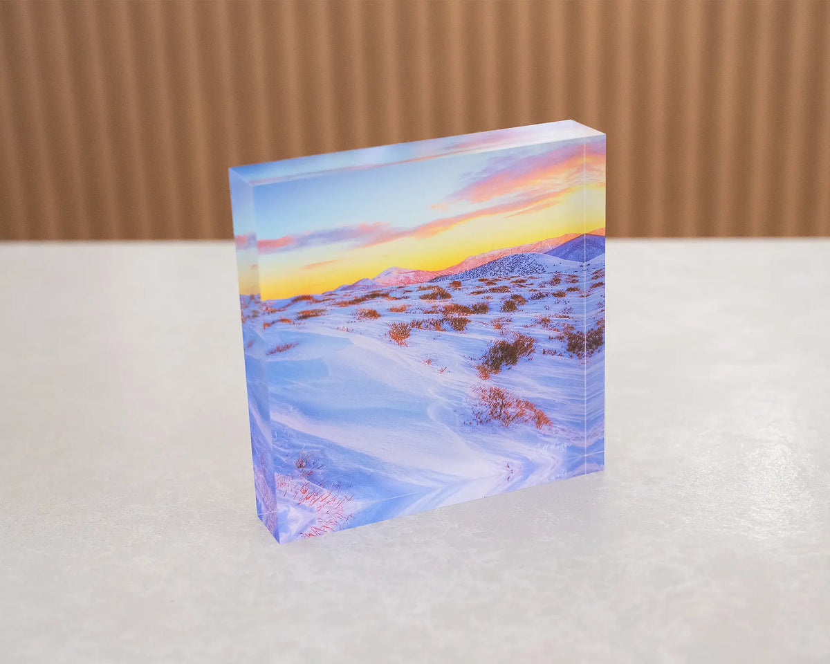 Razorback Dawn. Acrylic block of sunrise light over the Razorback leading to Mount Feathertop, sitting on a desk.