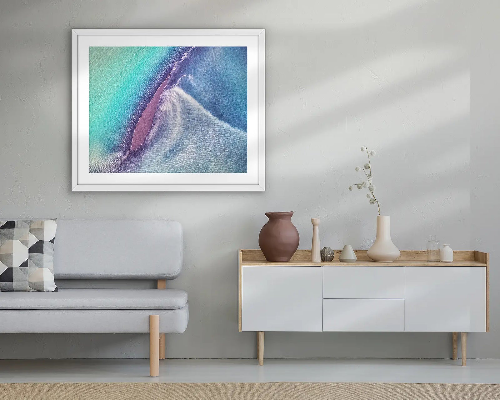 Framed abstract photograph of waves with turquoise, purple and white colours.