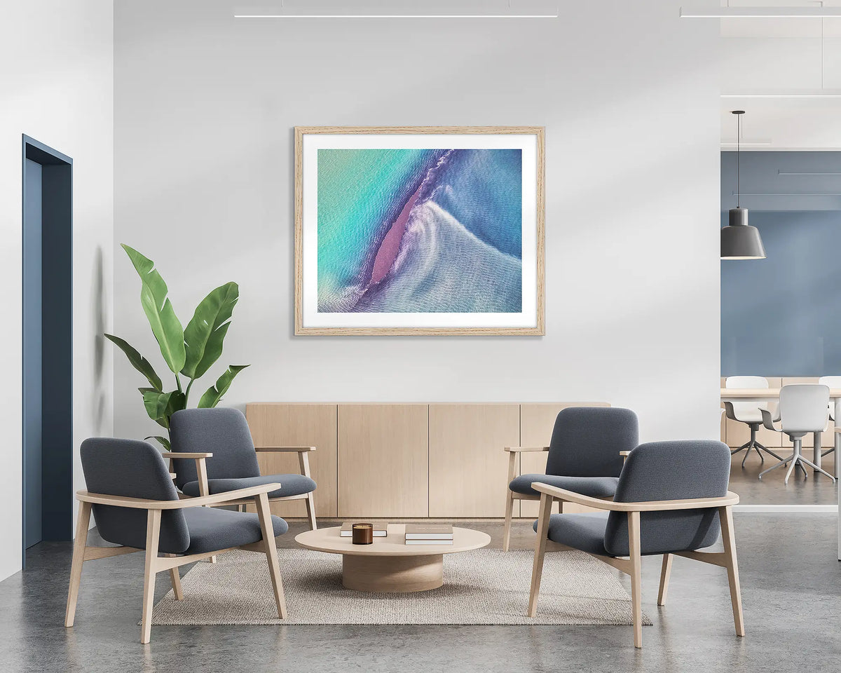 Recline.  Aerial abstract wall art print with a Tasmanian Oak frame, hung on the wall of a waiting area.