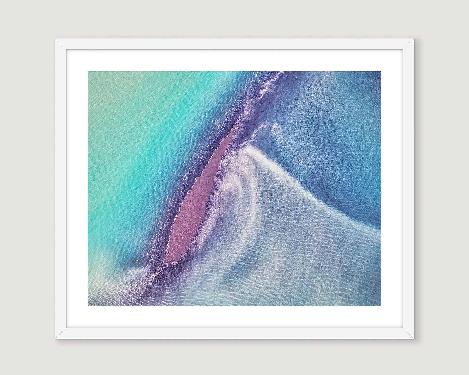 Framed abstract photograph of waves with turquoise, purple and white colours.