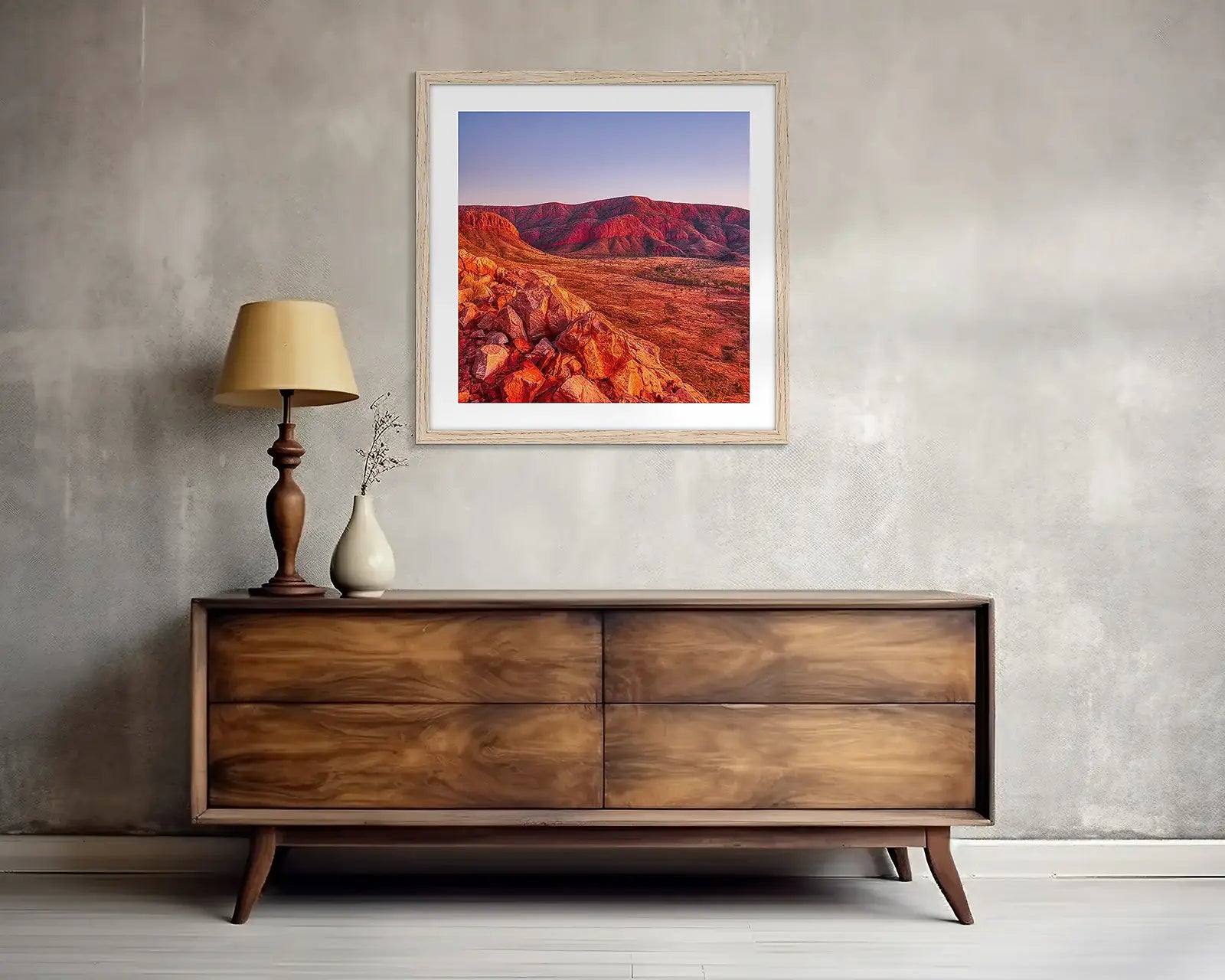Red outback wall art print above side table.
