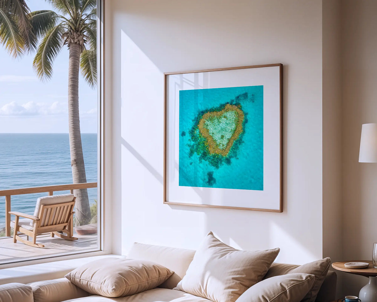 Reef romance. Photographic wall art print of Heart Reef, Queensland, with a timber frame, hung in a coastal house.