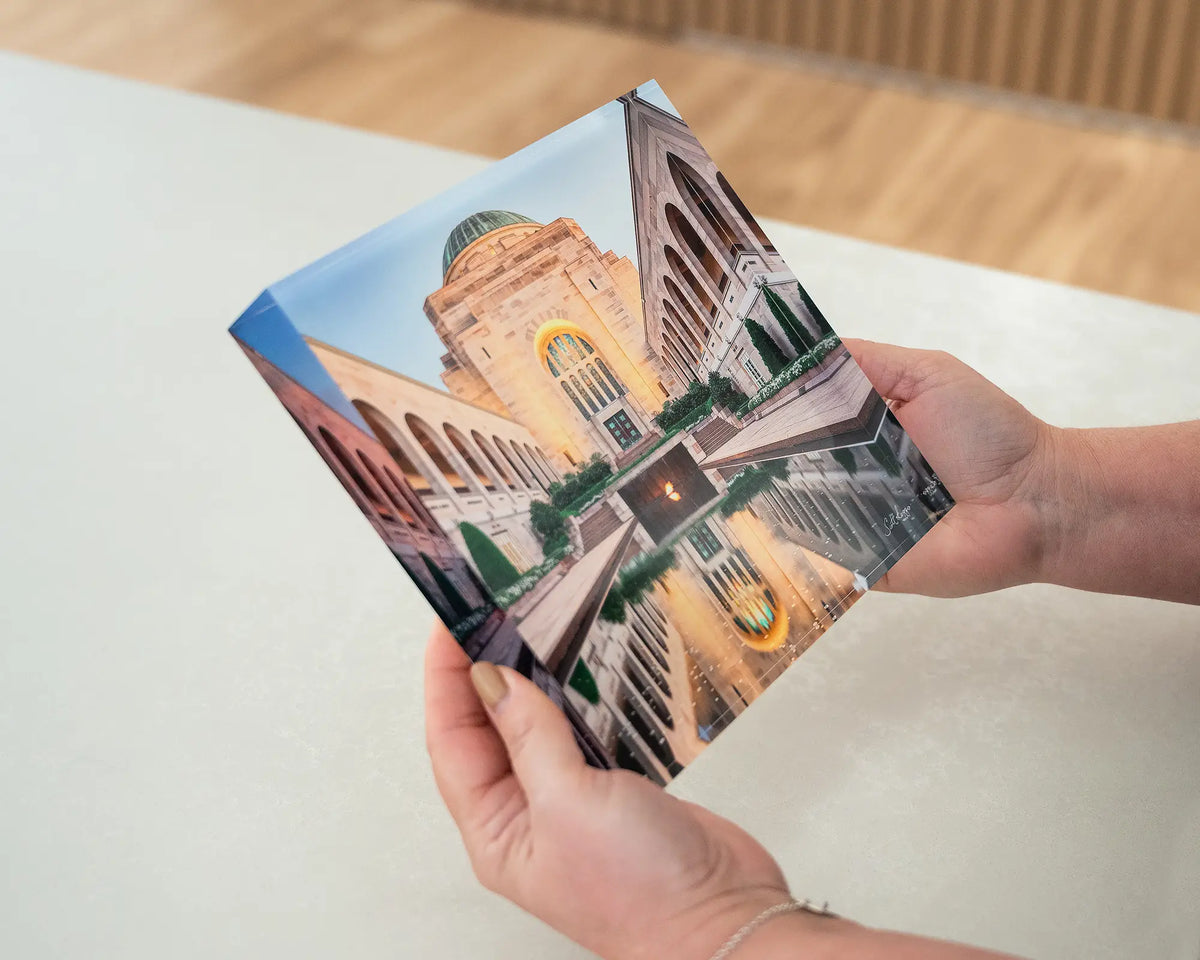 Reflection. Acrylic block of the Australian War Memorial Canberra, being hand held.