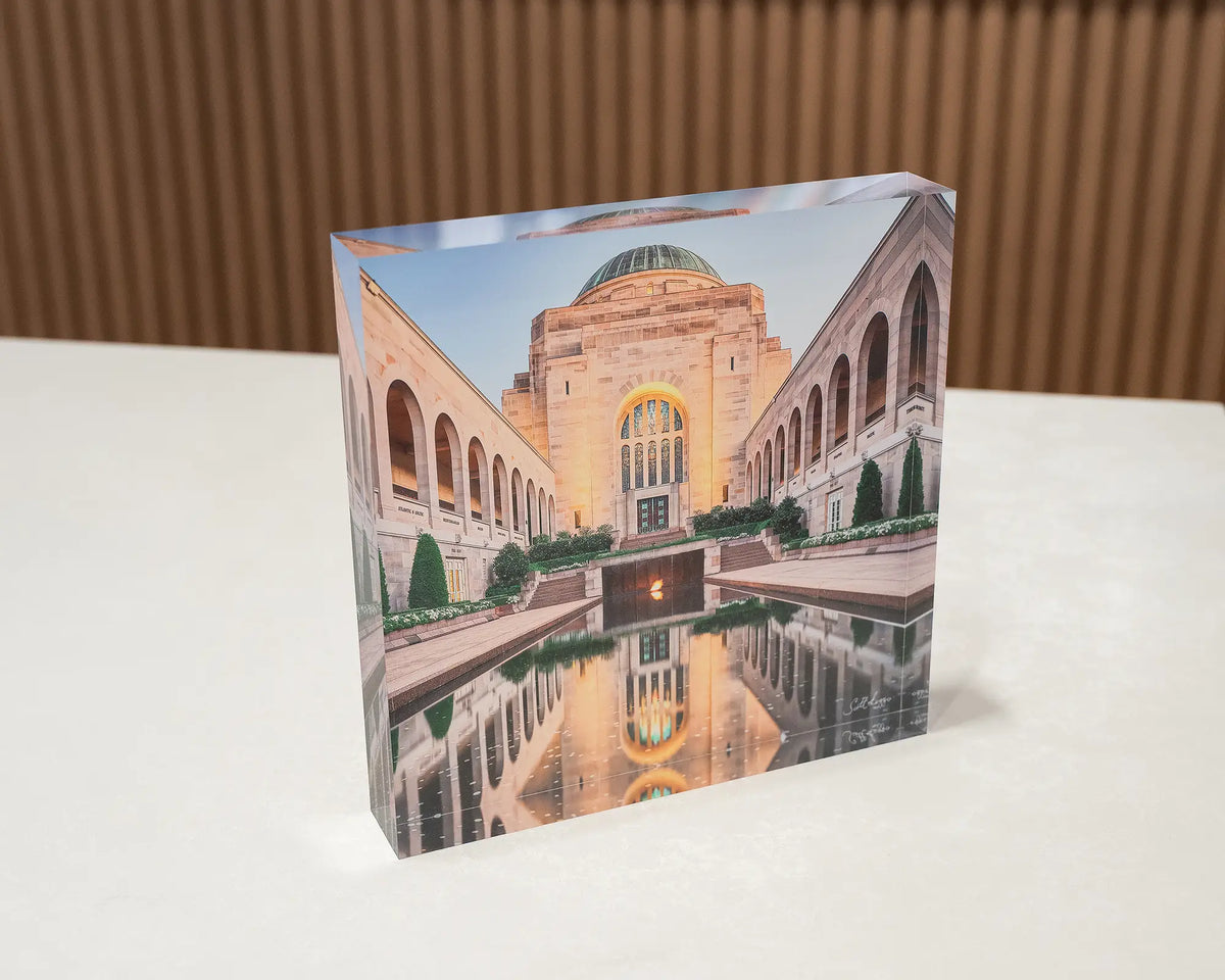 Reflection. Acrylic block of the Australian War Memorial Canberra, sitting on a desk.