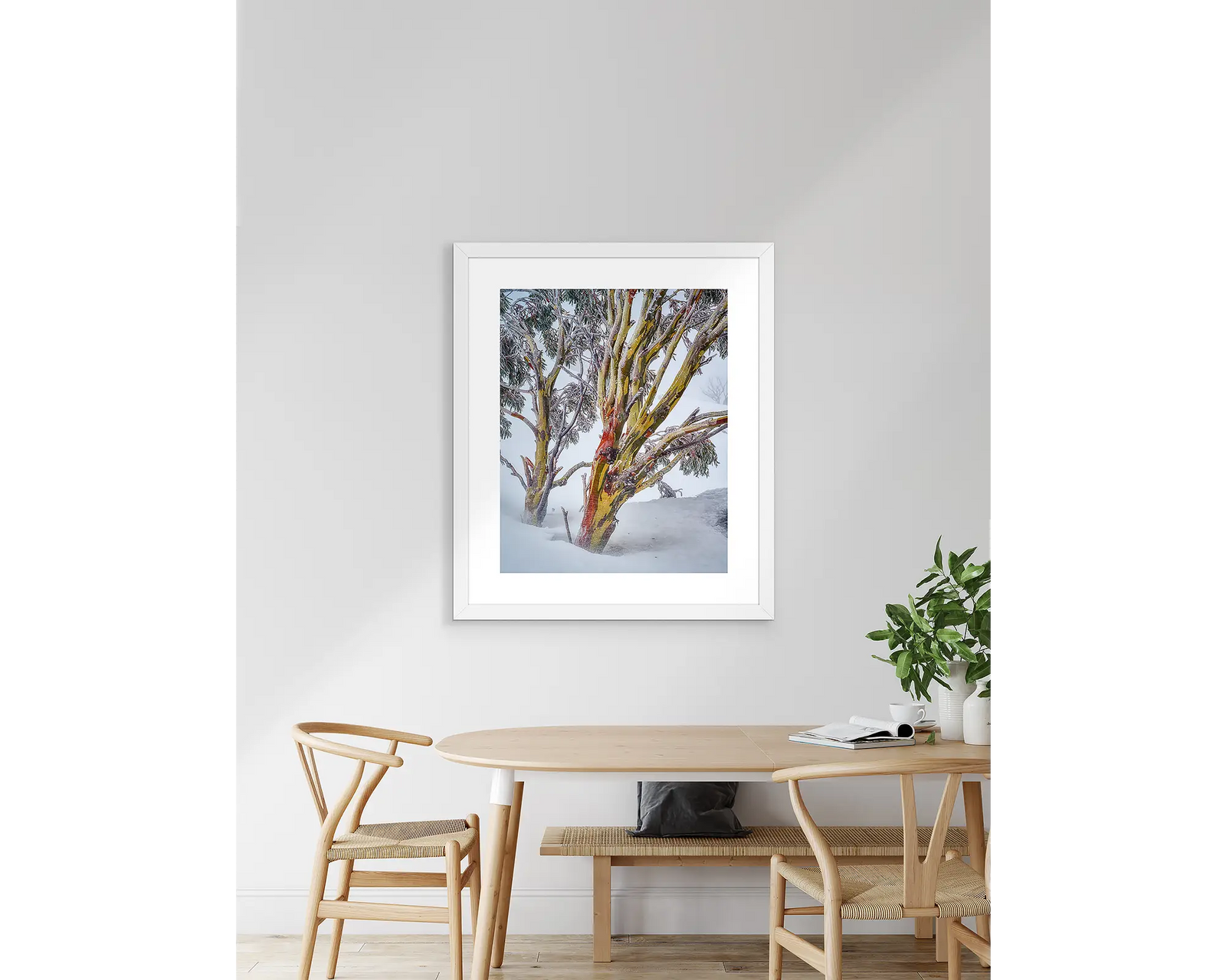 Framed landscape photograph of two snow gums in heavy snow.