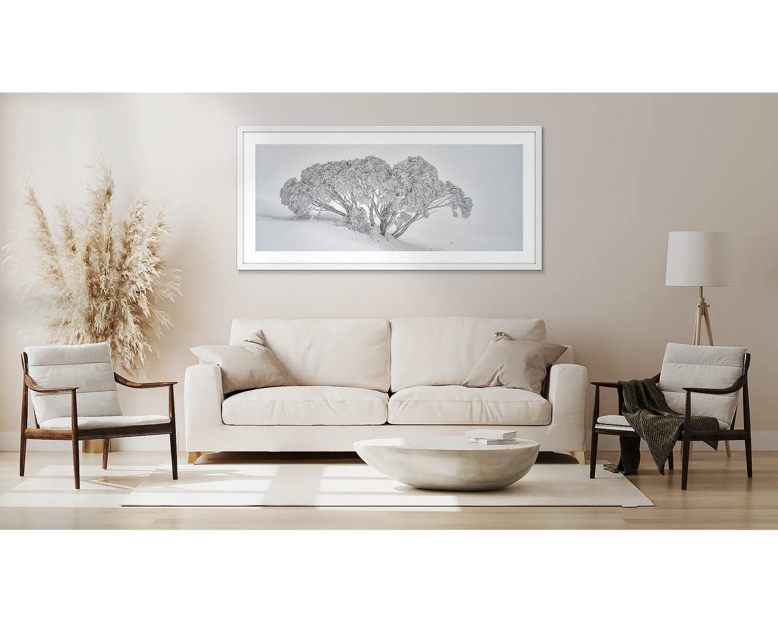 Framed grey and white landscape photograph of a snow gum in heavy snow.