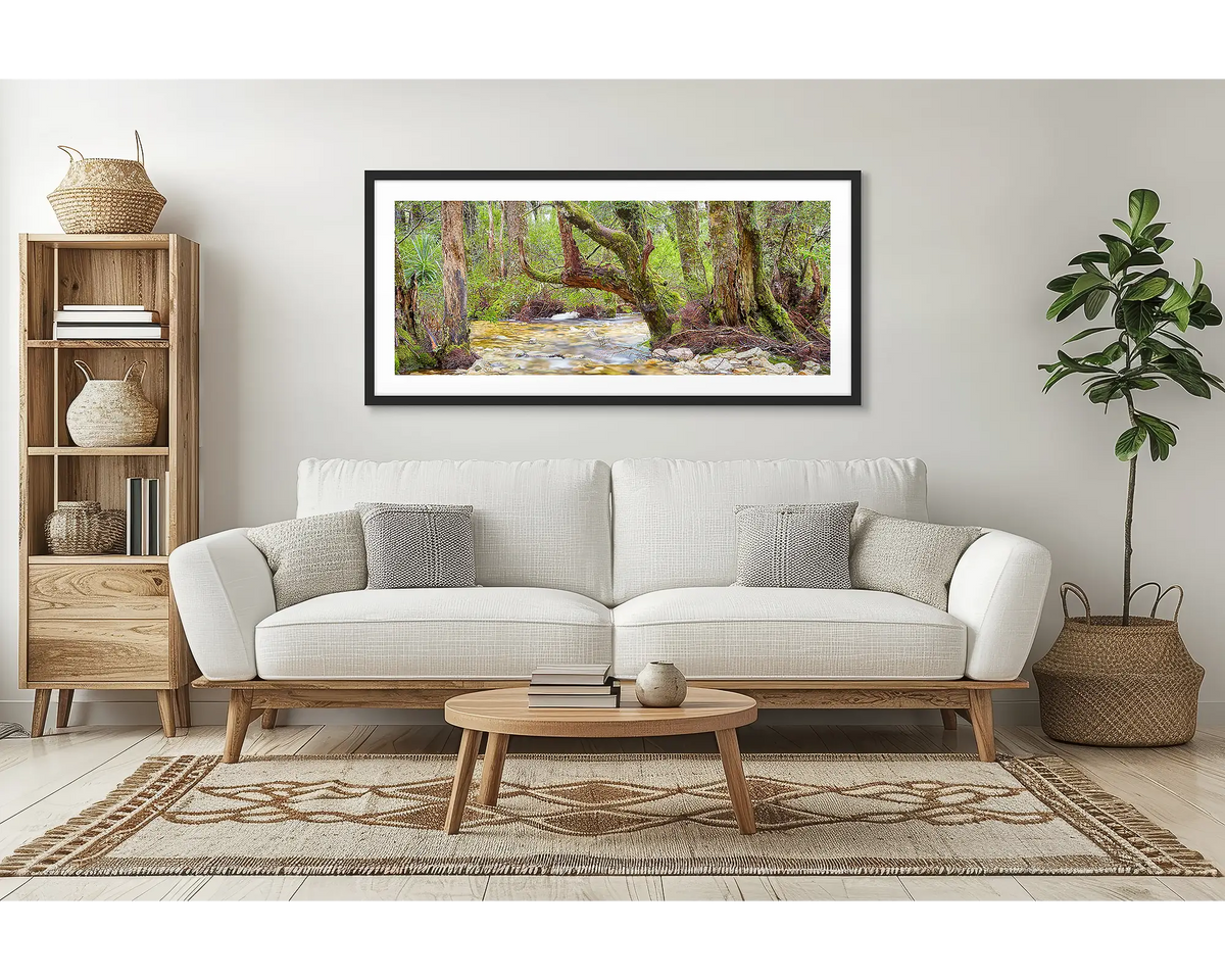 Reverie. Cradle Mountain Lake St Clair wall art print framed with a black frame, hung above a couch in a lounge room. 