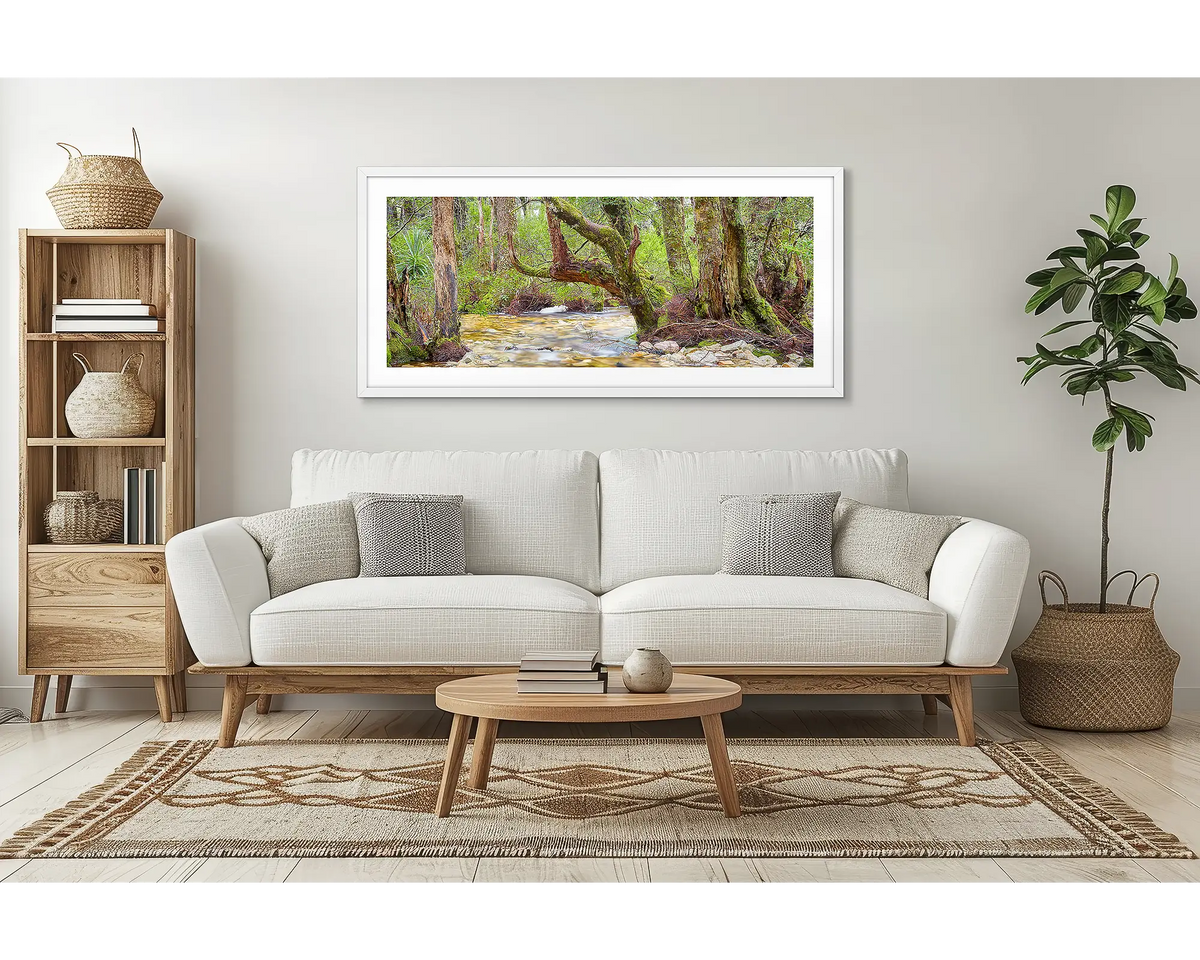 Reverie. Cradle Mountain Lake St Clair wall art print framed with a white frame, hung above a couch in a lounge room. 