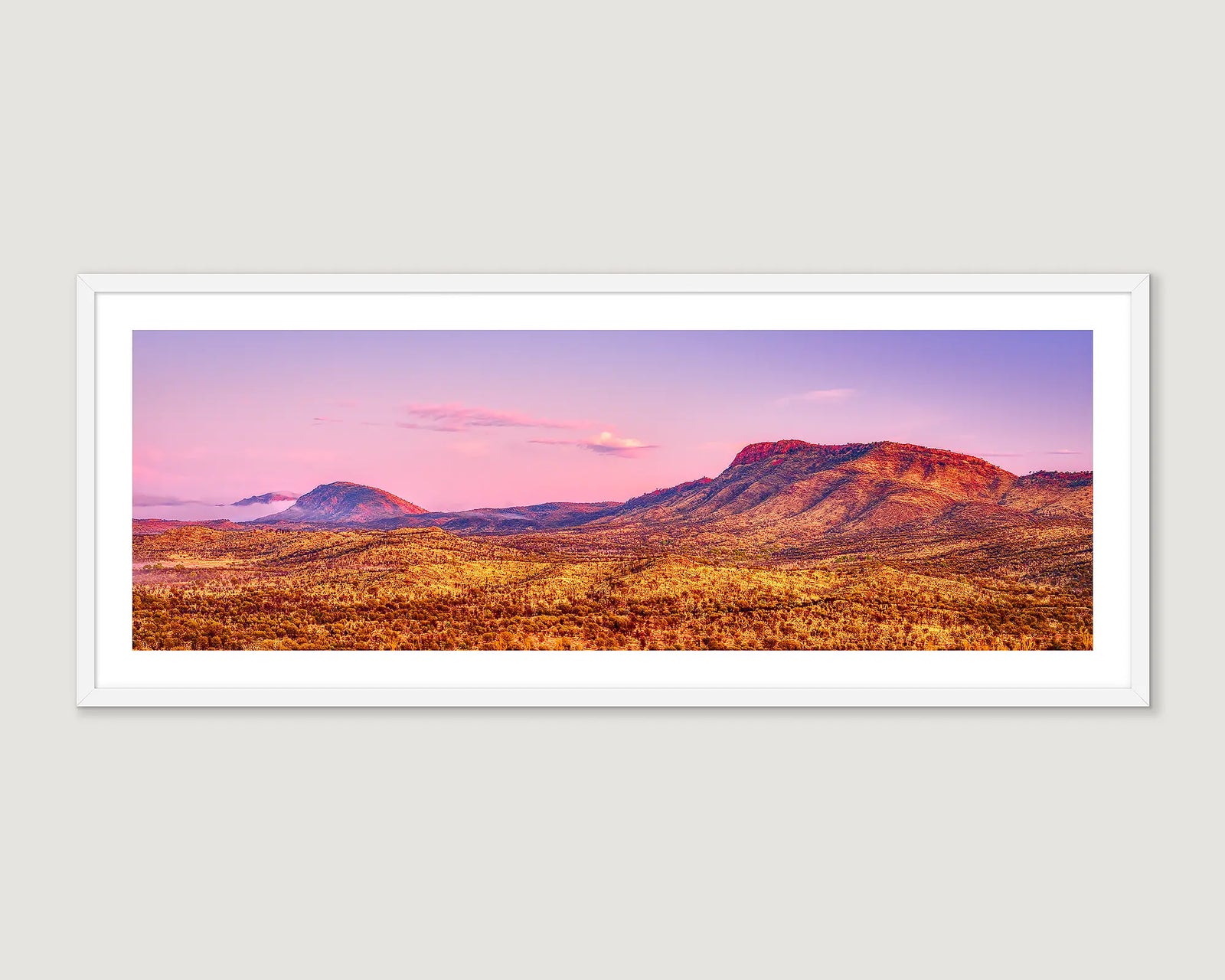 Framed panoramic photograph of desert rock formations with a purple and blue sunset in Tjoritja / West MacDonnell National Park.