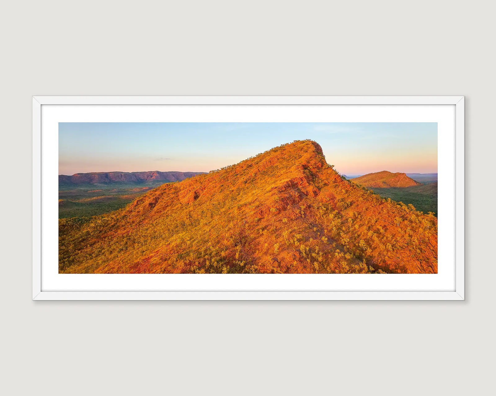 Framed photograph of red rock formations with blue sky and greenery in the East Kimberley.