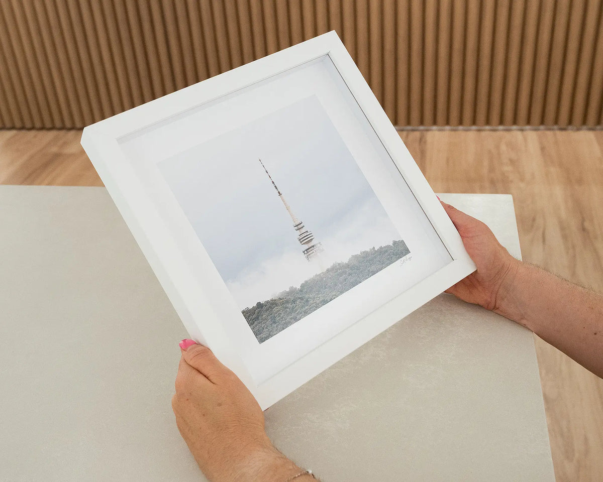 Rising. Black Mountain tower Canberra in fog, with white frame being hand held.