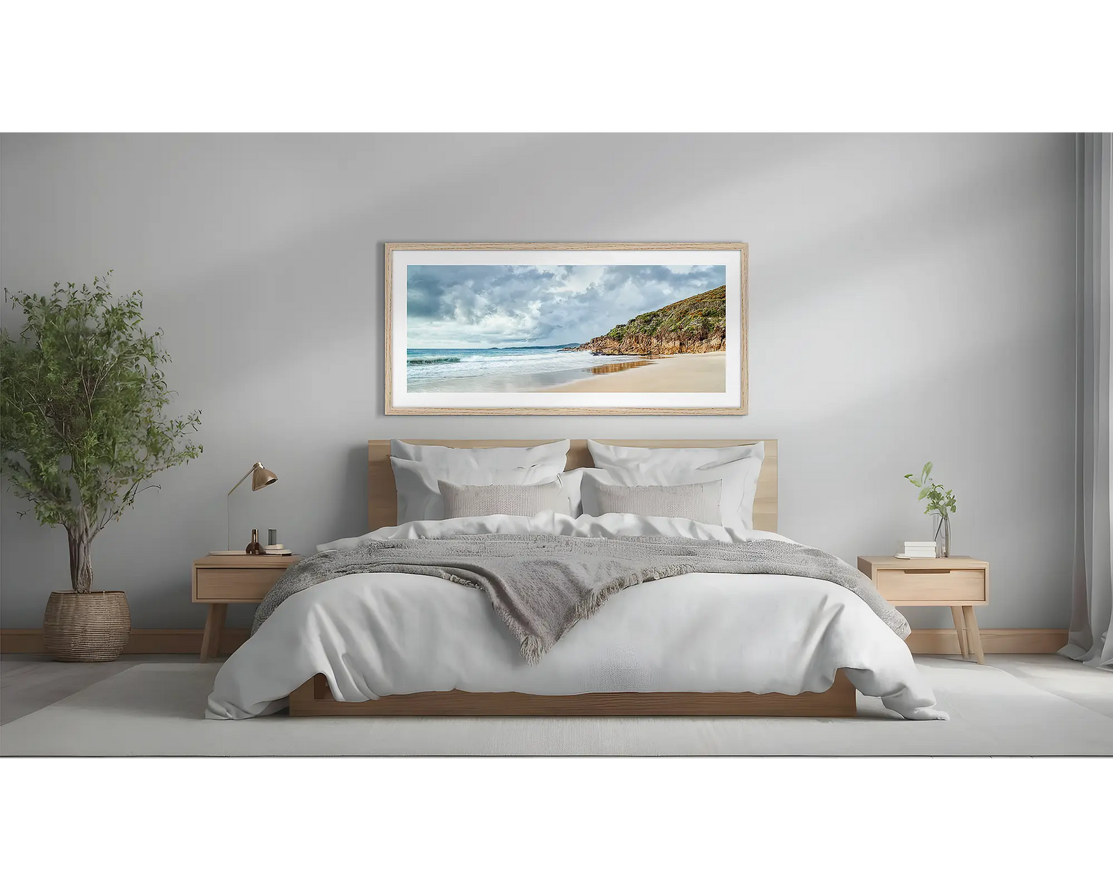 Framed artwork of a beach scene at Zenith Beach with a rocky cliff and cloudy sky.