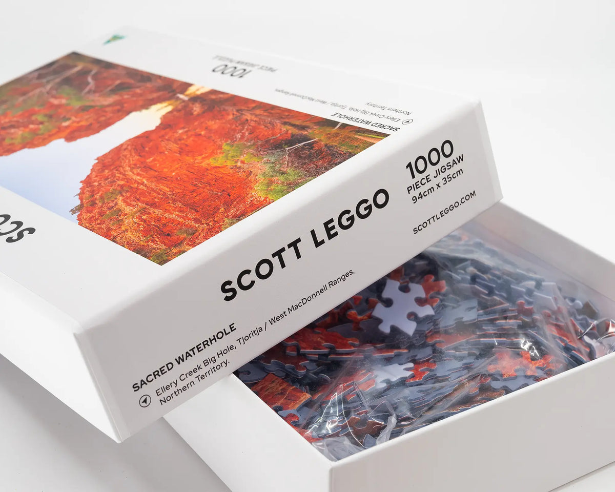 Sacred Waterhole. 1000 piece jigsaw puzzle, West Macdonnell Ranges, Northern Territory, open box showing puzzle pieces.
