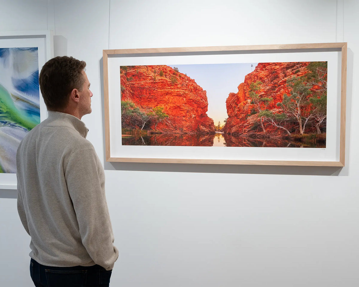 Sacred Waterhole. Ellery Creek Big Hole, Northern Territory, in gallery with person admiring.
