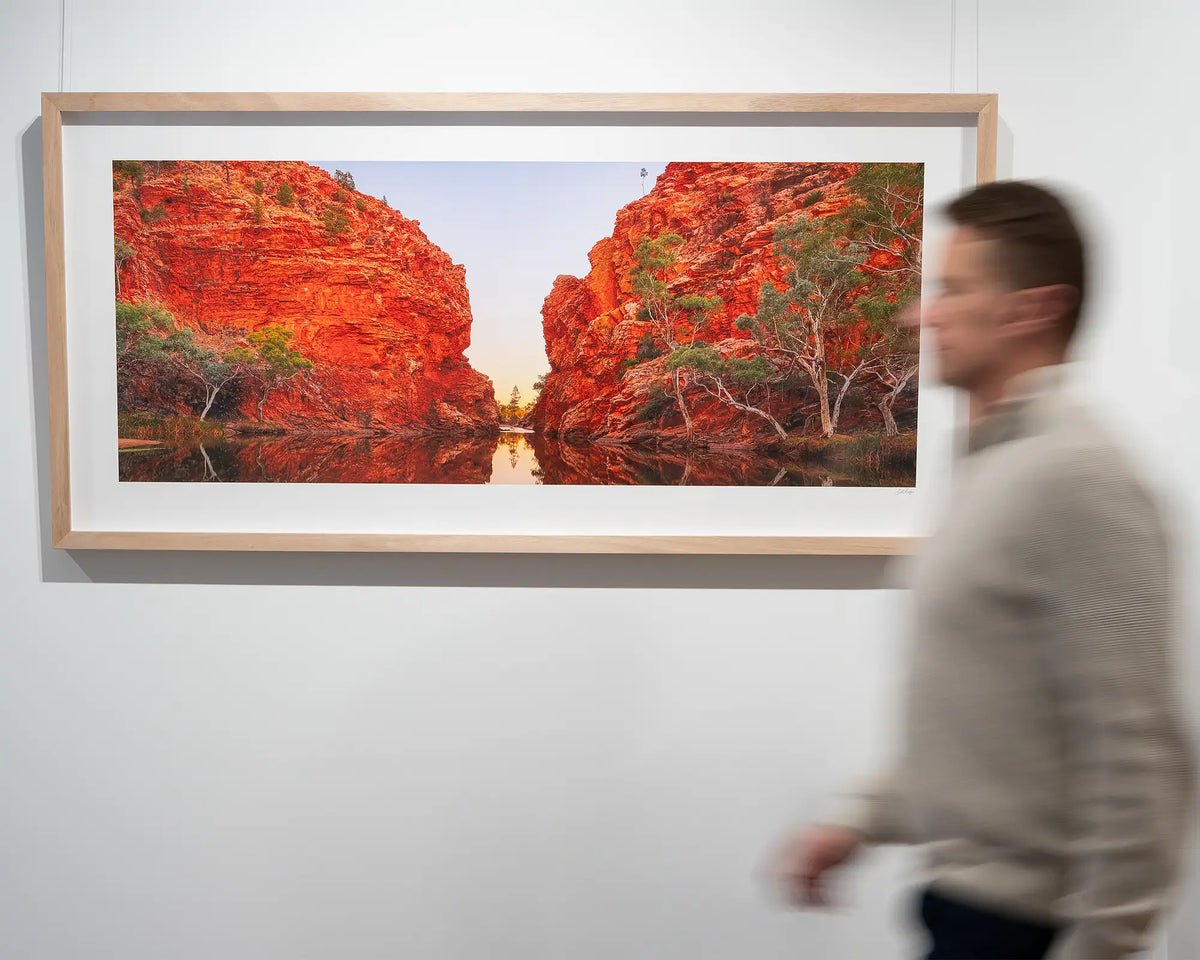 Sacred Waterhole. Ellery Creek Big Hole, Northern Territory, in gallery with person walking in front.