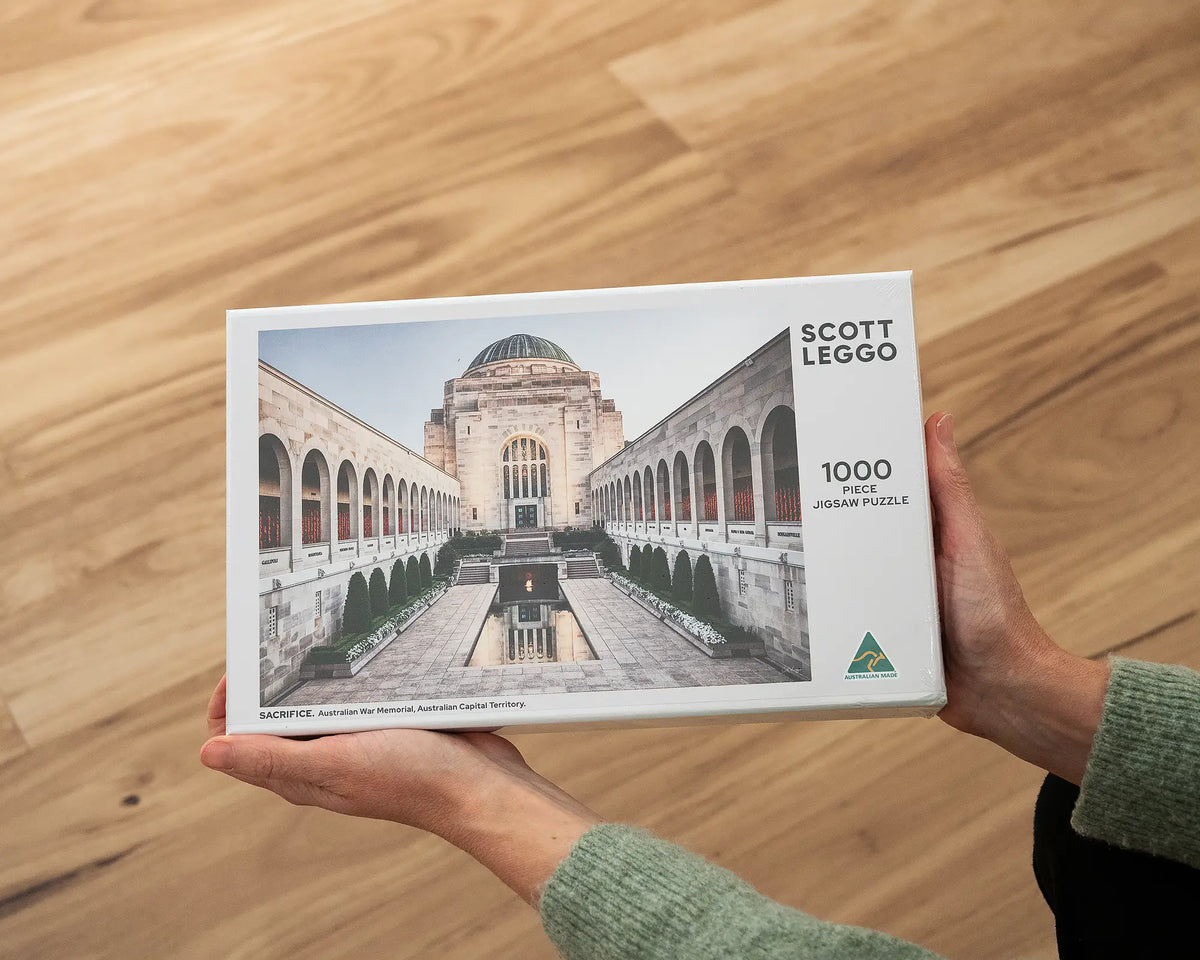 Sacrifice 1000 piece War Memorial jigsaw puzzle box being held.