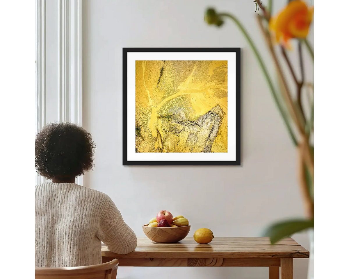 Sand Mining. Square abstract wall art with a black frame, hung on a kitchen wall with a woman admiring. 