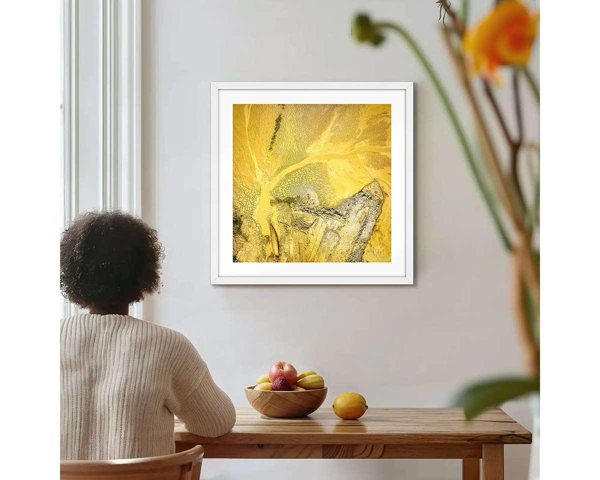 Sand Mining. Square abstract wall art with a white frame, hung on a kitchen wall with a woman admiring. 