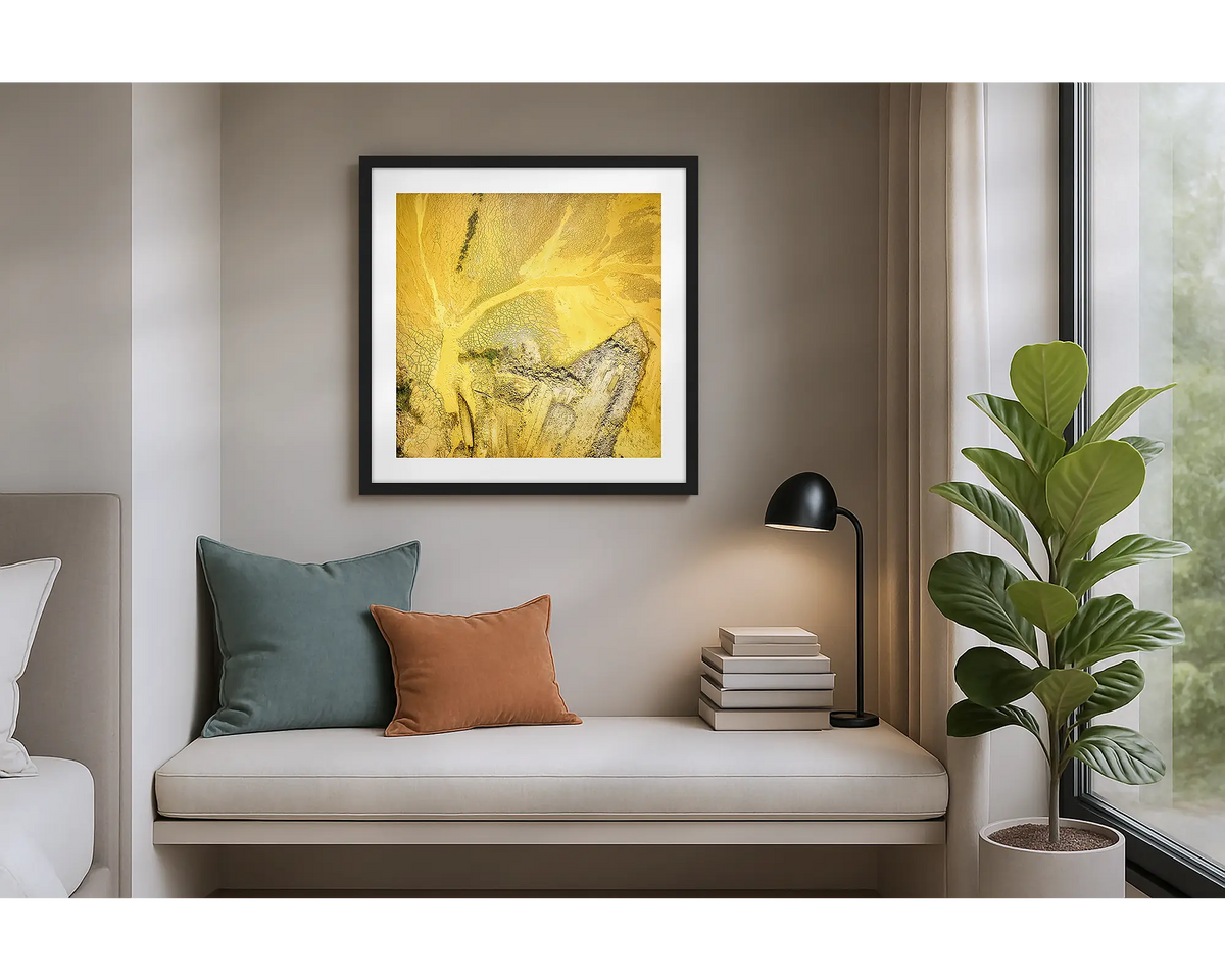 Sand Mining. Wall art print of a mining site viewed from above, with a black frame, hung in an apartment. 