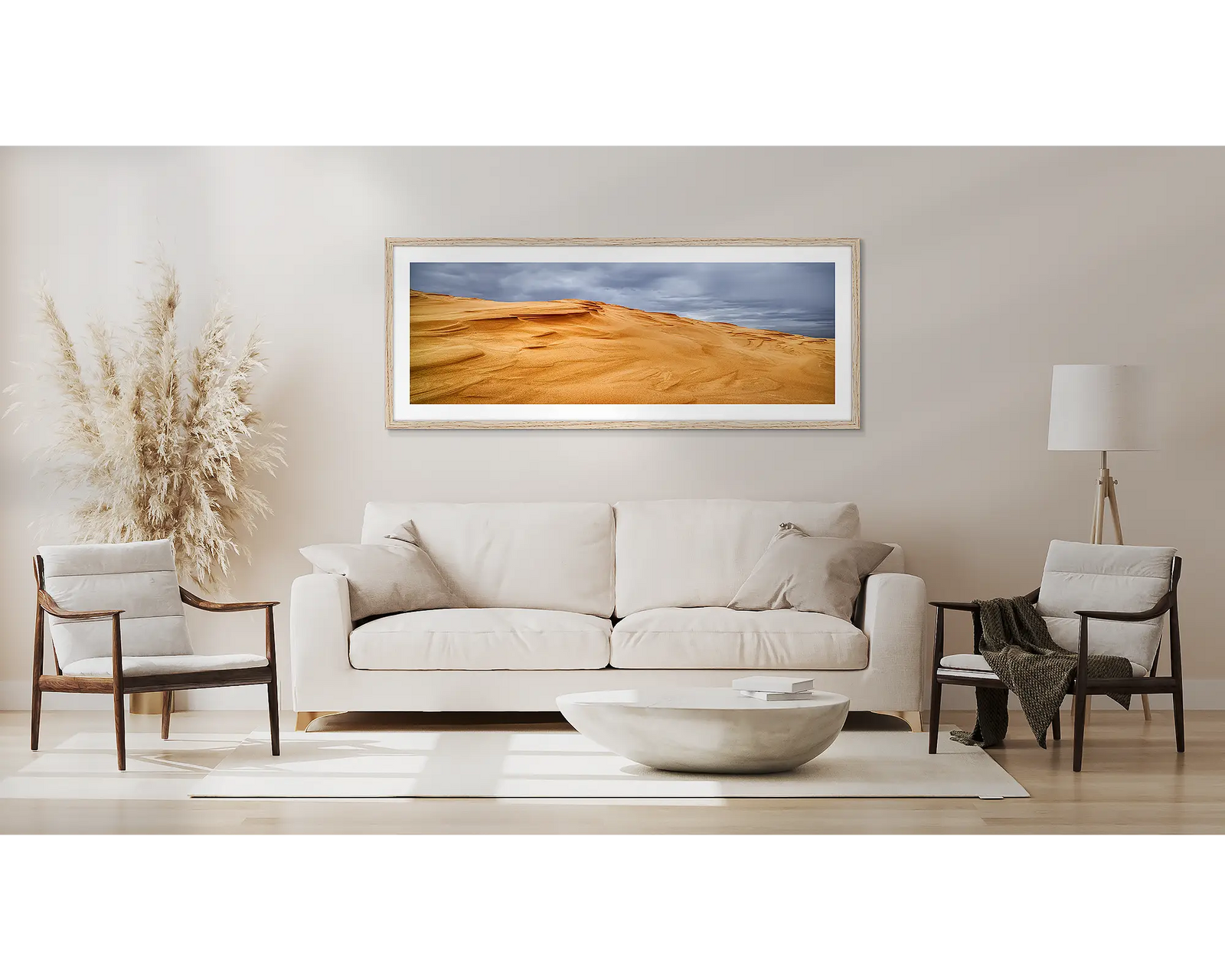 Framed artwork of sand dunes at Stockton Beach with a cloudy sky.