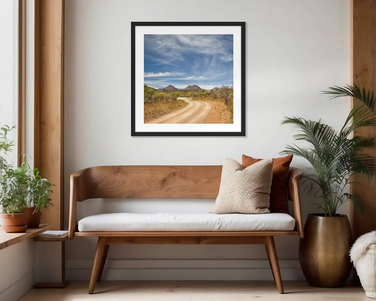 Scenic Drive. Black framed wall art print of Flinders Ranges, hung in a scandi-themed waiting area.