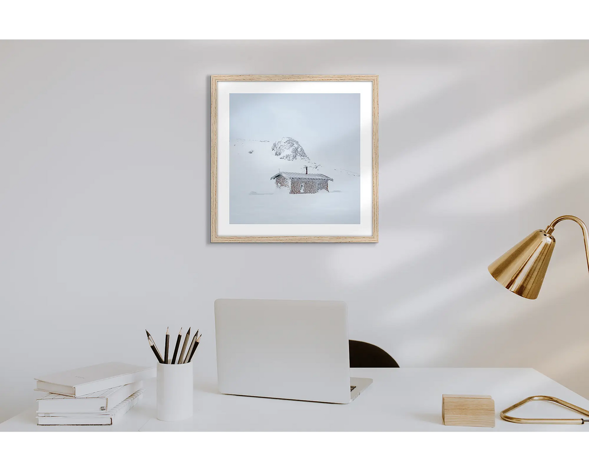 Seaman&#39;s Hut. Wall art print of Seaman&#39;s Hut covered in snow and ice, with a timber frame in a work from home office.  
