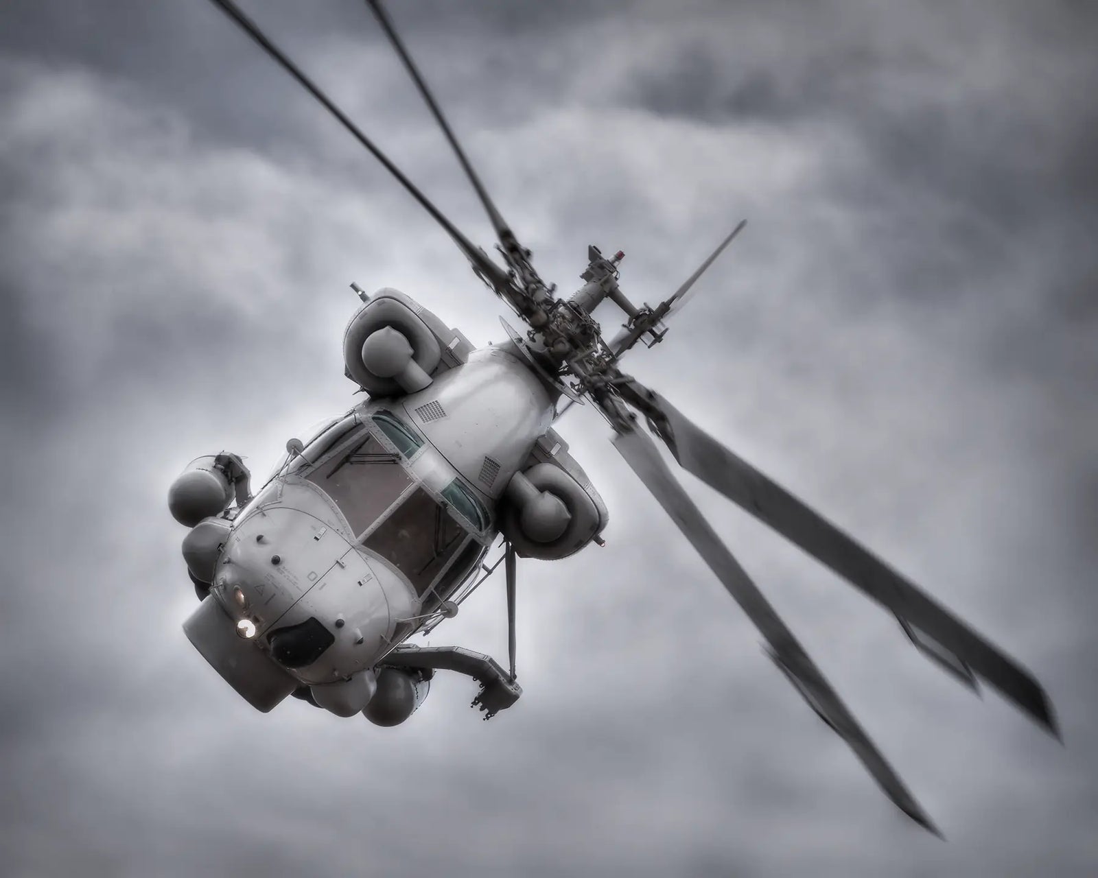Seasprite helicopter head on with clouds in background.