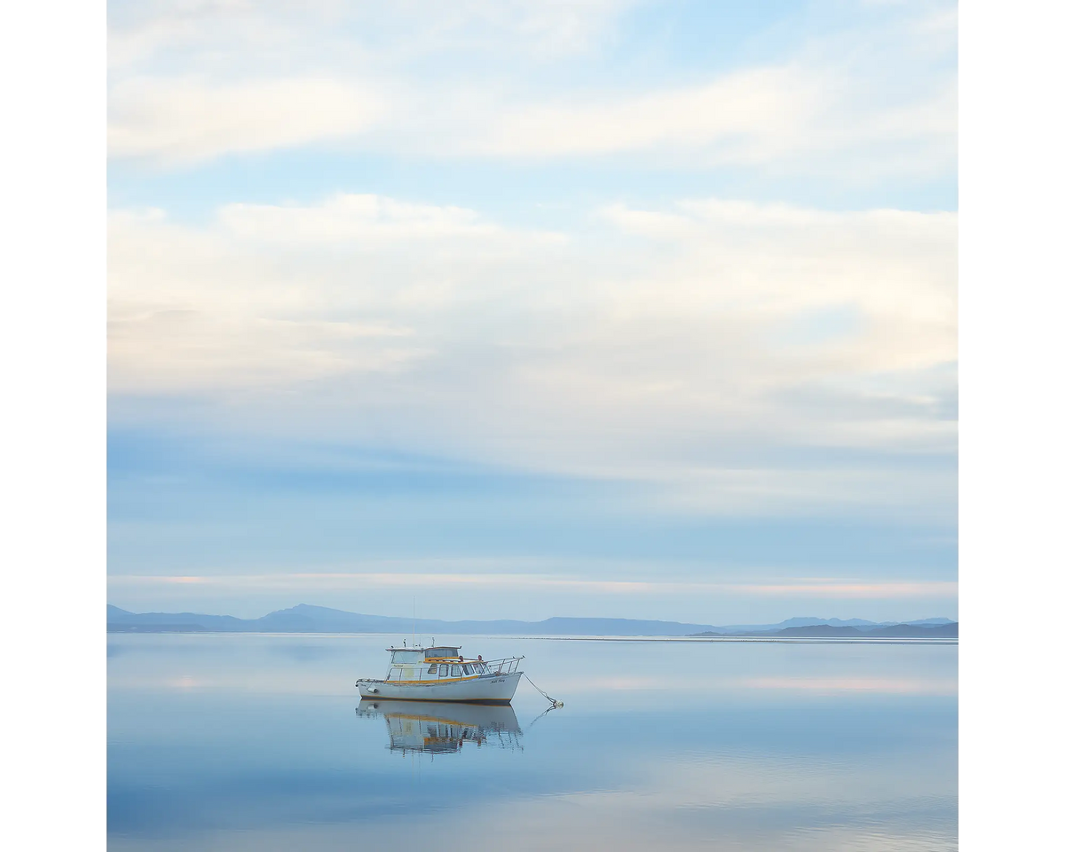 Serenity. Moored boat on still waters, Macquarie Harbour, Tasmania.