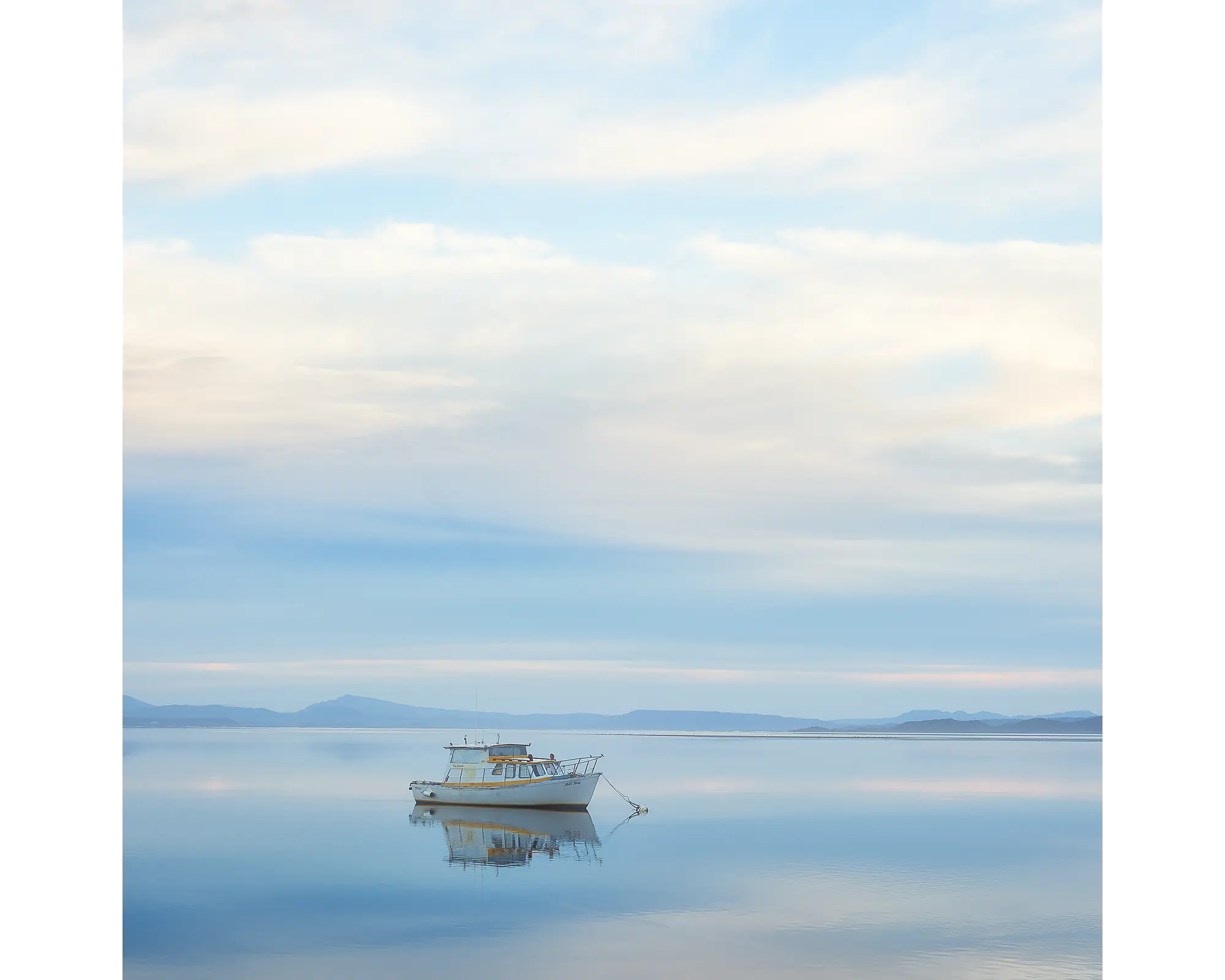 Serenity. Moored boat on still waters, Macquarie Harbour, Tasmania.