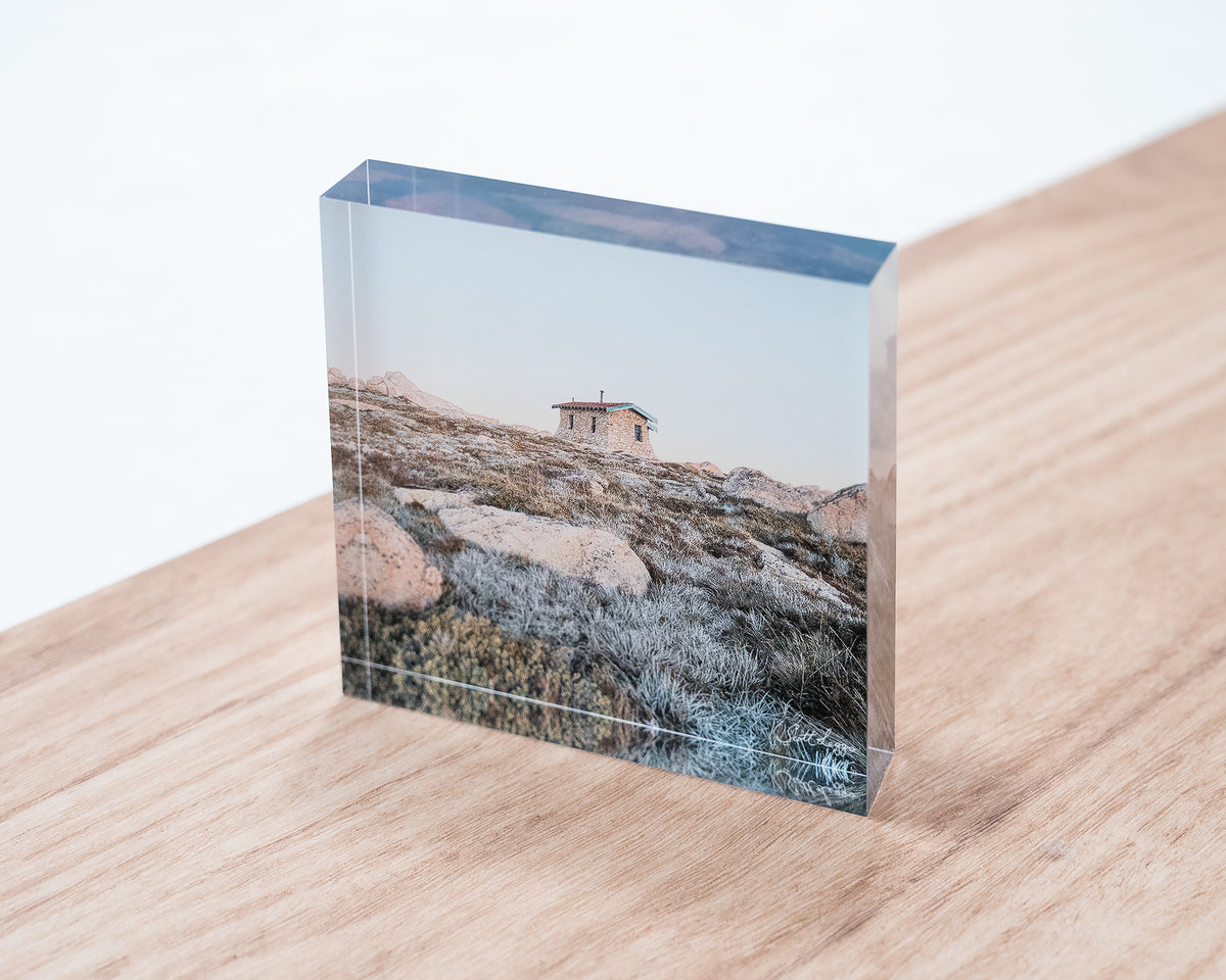Shelter. Acrylic block Seamans Hut Kosciuszko National Park, New South Wales, displayed on desk.