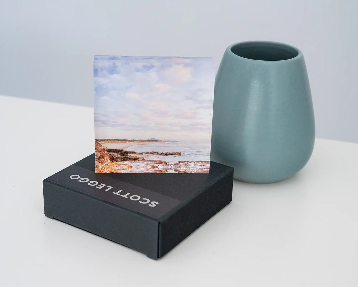 Shoreline. Acrylic block of Mudjimba Beach, Sunshine Coast, Queensland, styled on a gift box with a small vase.