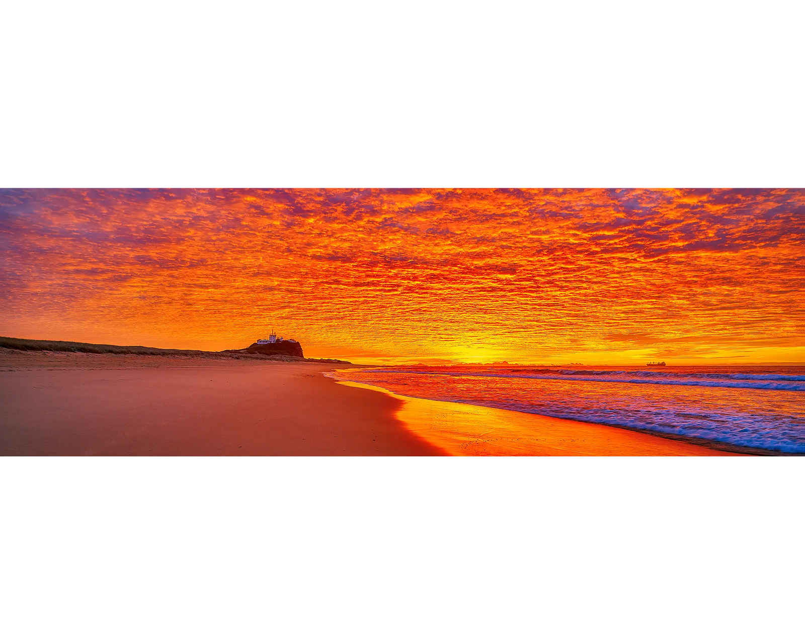 Sky Fire. Sunrise lighting the sky over Nobby's Beach, Newcastle, New South Wales, Australia.