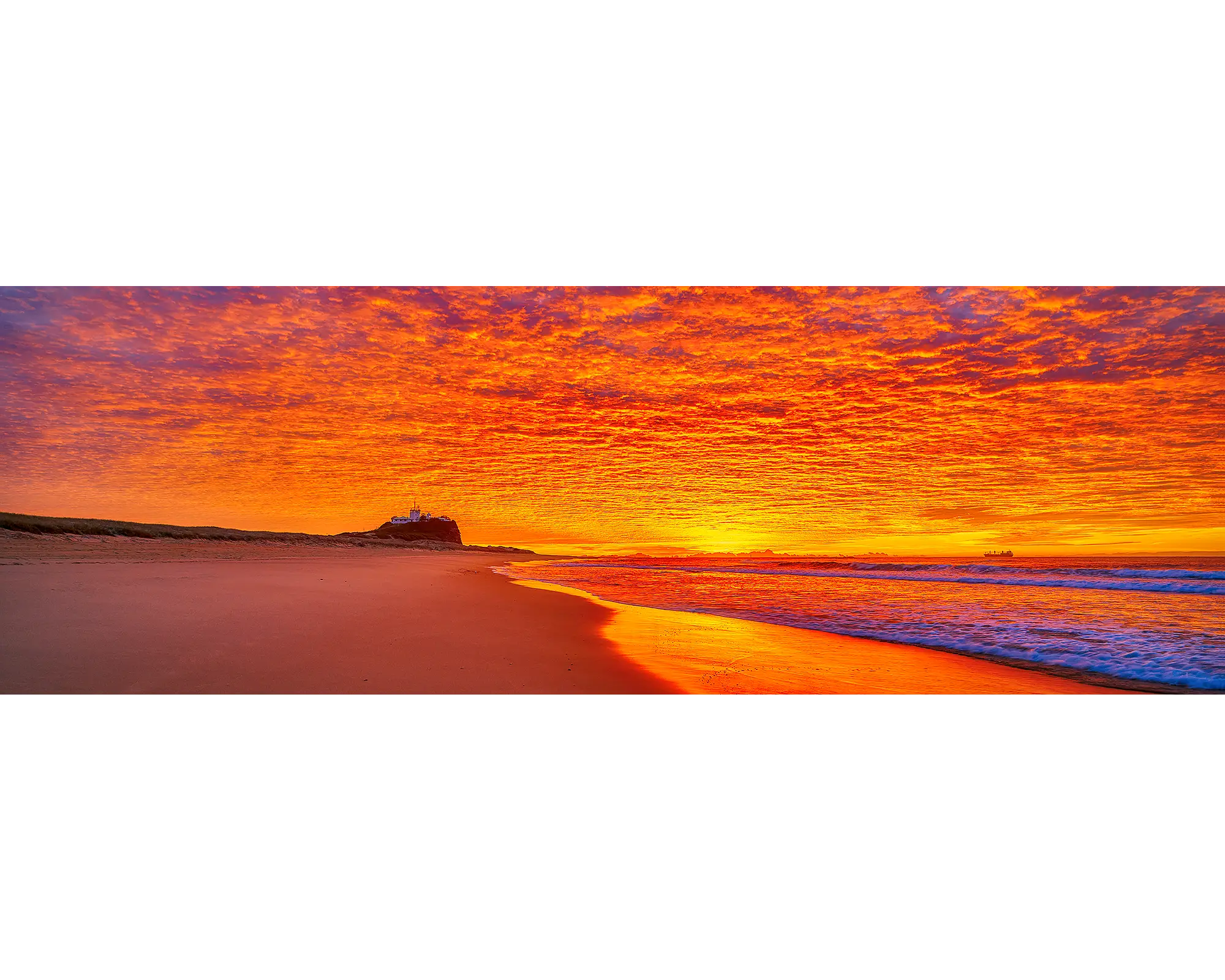 Sky Fire. Sunrise lighting the sky over Nobby's Beach, Newcastle, New South Wales, Australia.