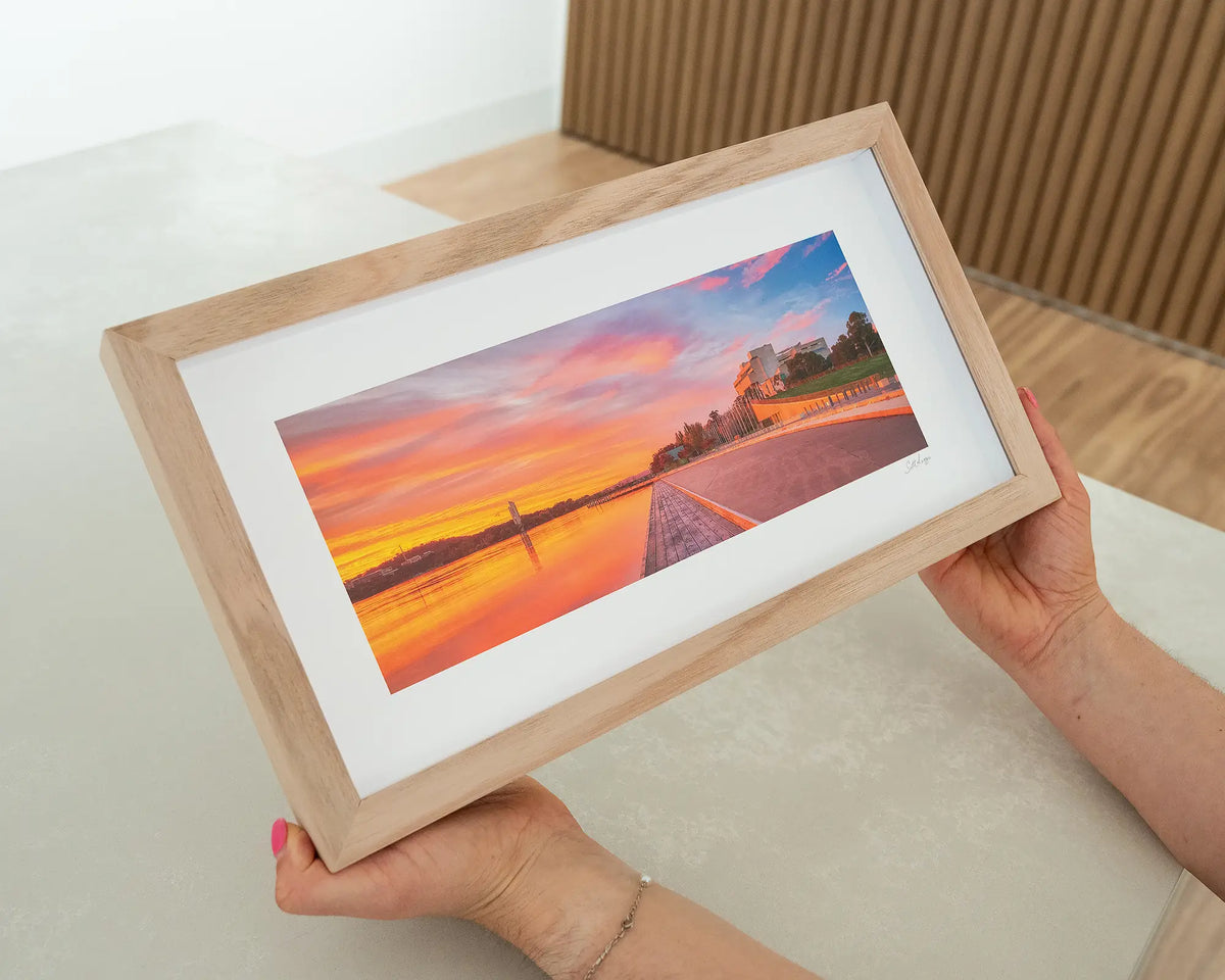Sky Light. Canberra sunrise over Lake Burley Griffin with timber frame being hand held.