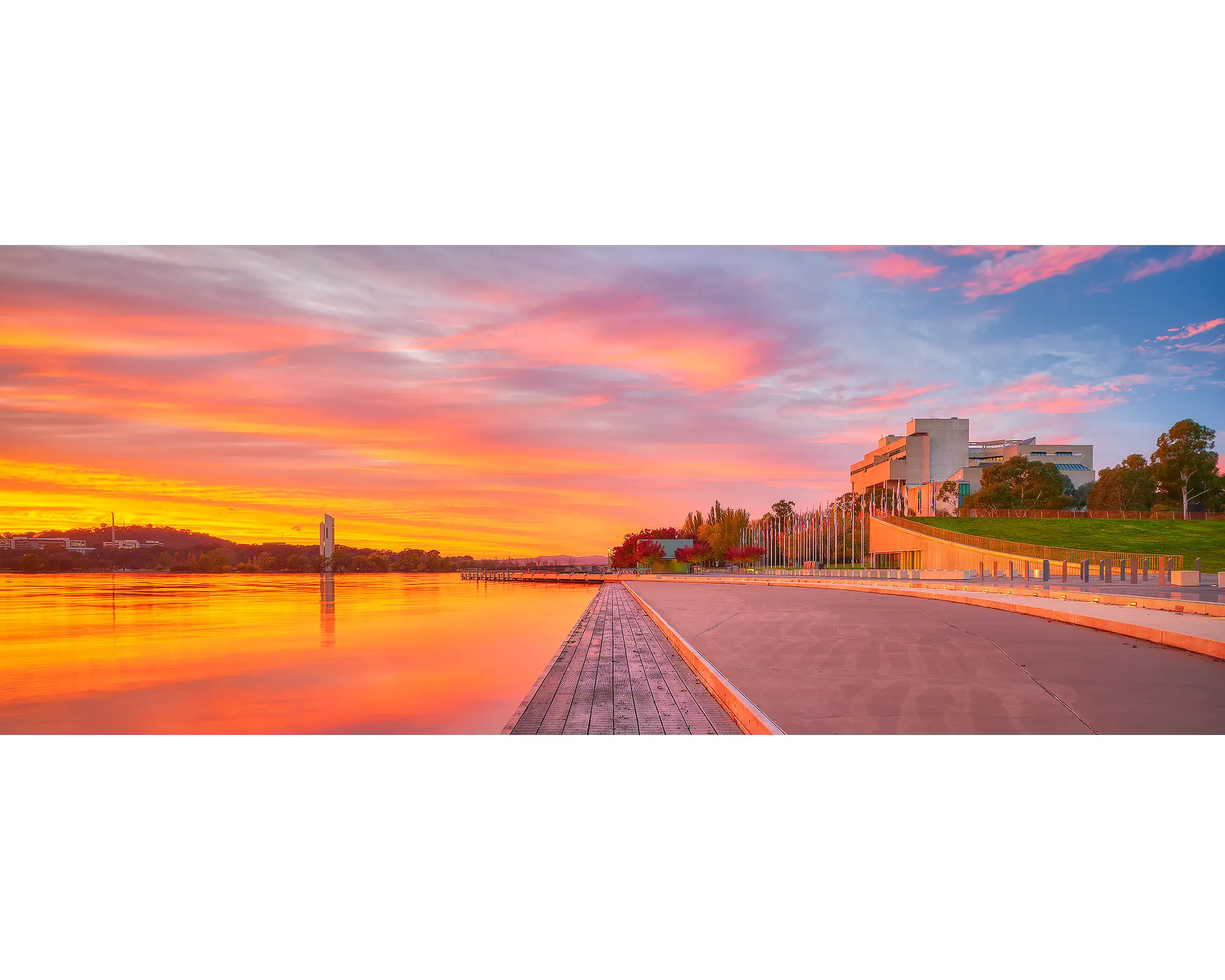 Sky Light. Orange sunrise over Lake BUrley Griffin and The High Court, Canberra, Australia.